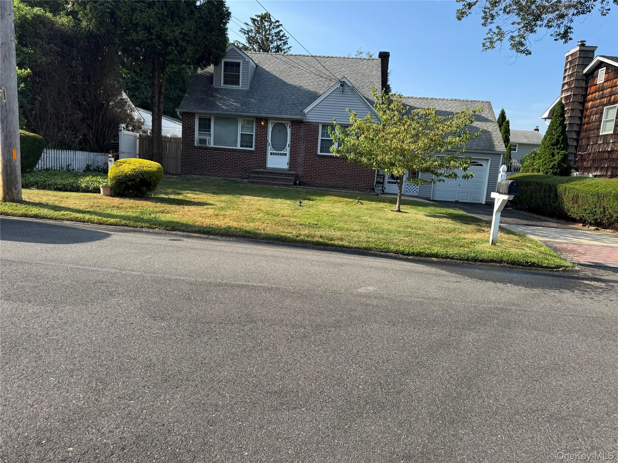 View of front of property with driveway, brick siding, roof with shingles, and an attached garage View of front of property with driveway, brick siding, roof with shingles, and an attached garage