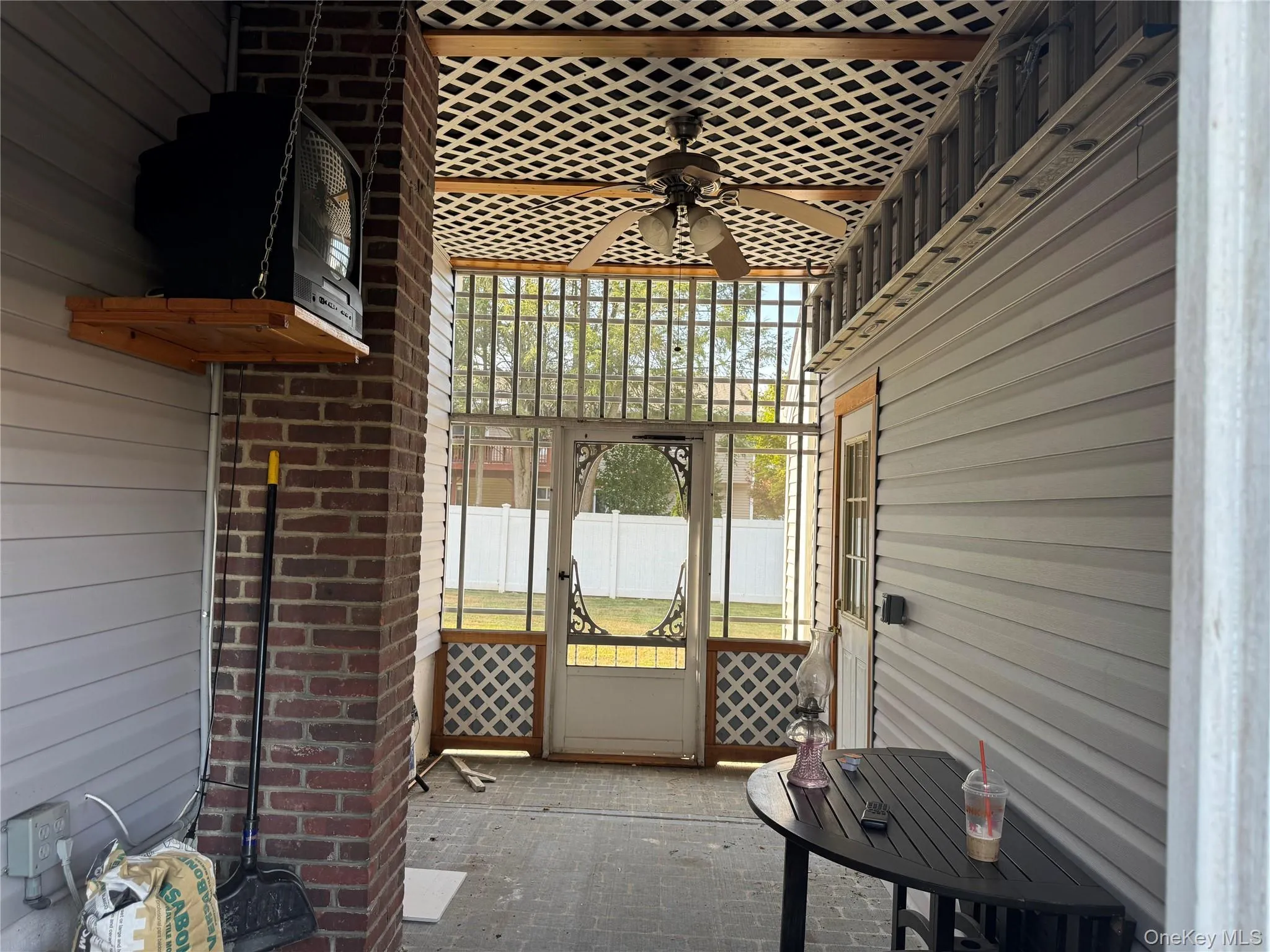 View of patio featuring a sunroom and a ceiling fan View of patio featuring a sunroom and a ceiling fan