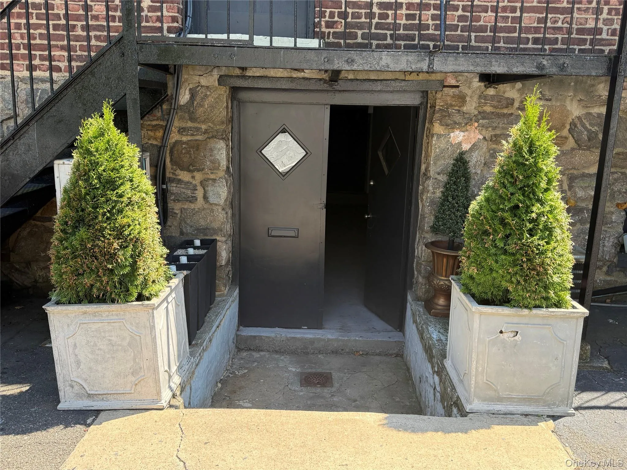 View of exterior entry with stone siding and brick siding View of exterior entry with stone siding and brick siding