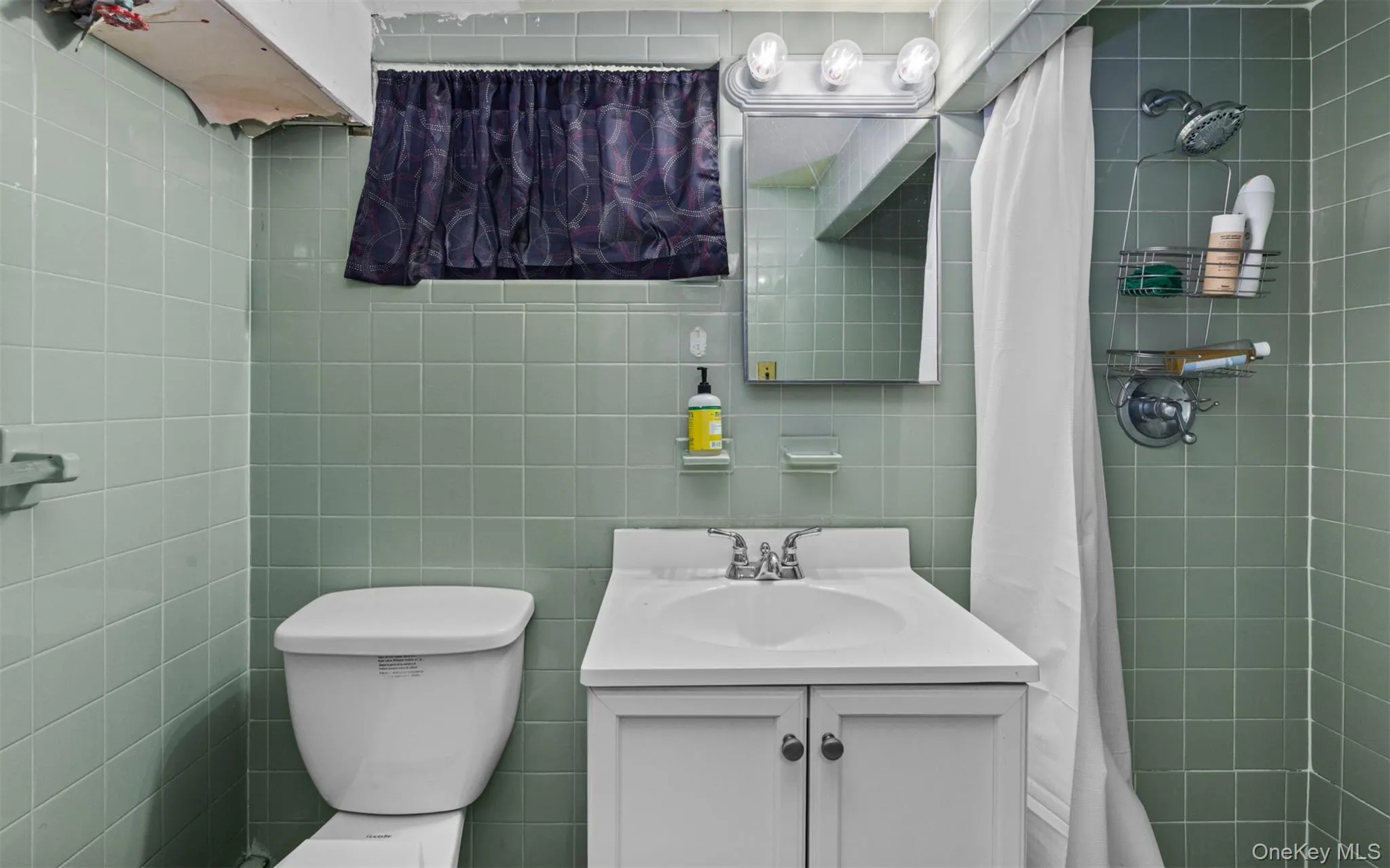 Full bathroom with vanity, tile walls, and a tile shower Full bathroom with vanity, tile walls, and a tile shower