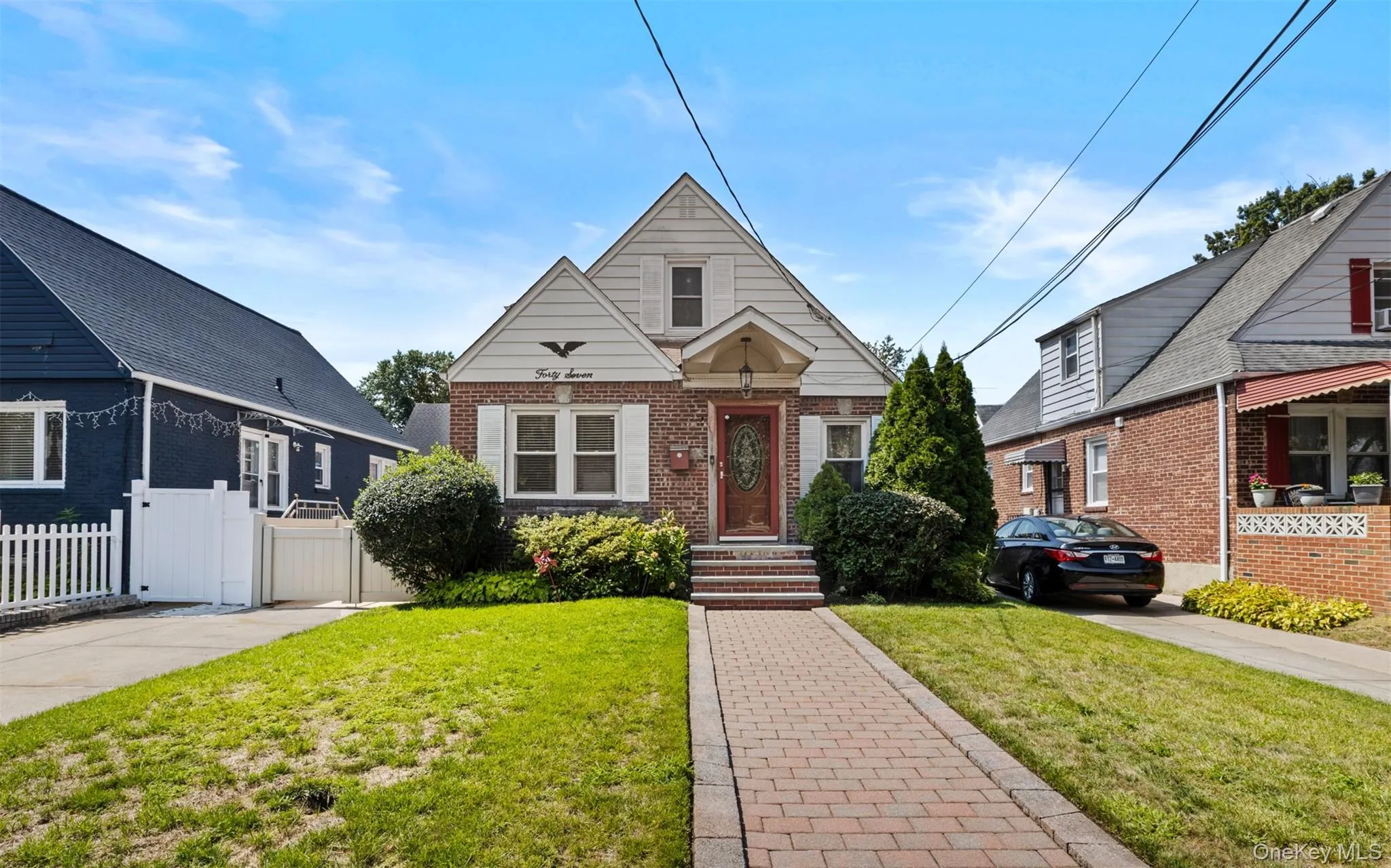 Bungalow-style house featuring brick siding and a gate Bungalow-style house featuring brick siding and a gate