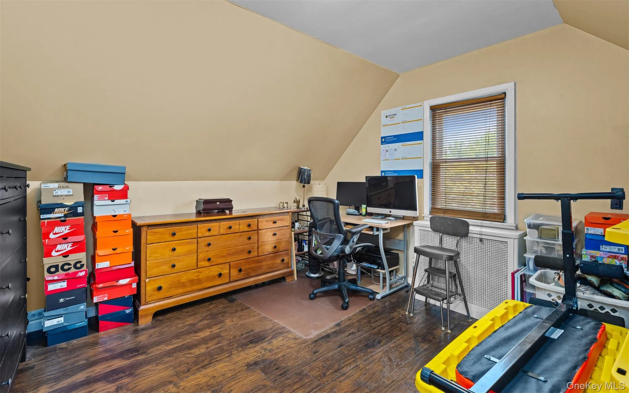 Home office featuring vaulted ceiling and dark wood finished floors Home office featuring vaulted ceiling and dark wood finished floors