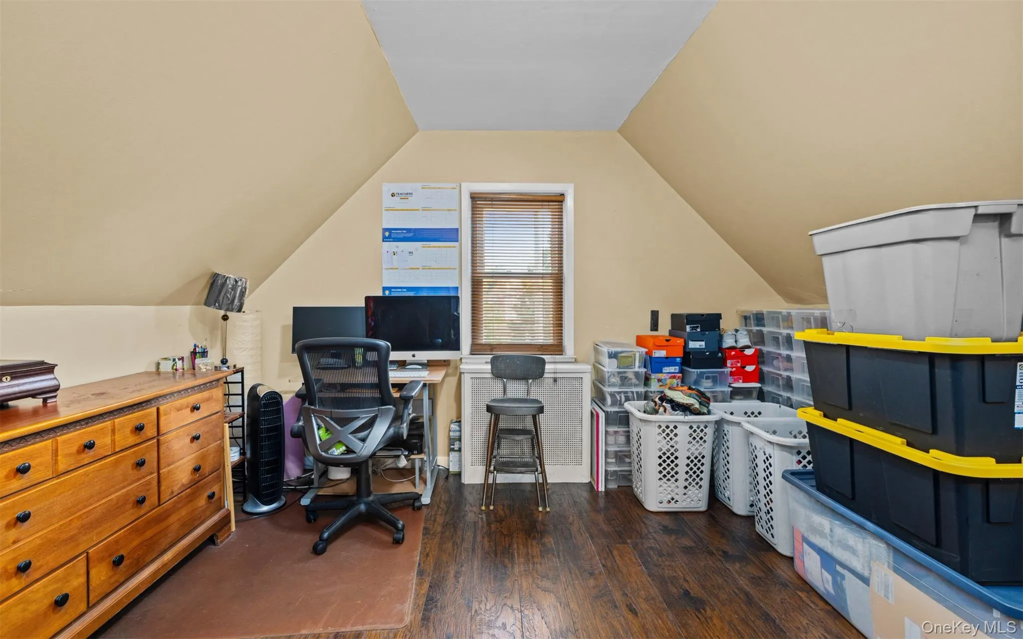 Home office with dark wood-type flooring and vaulted ceiling Home office with dark wood-type flooring and vaulted ceiling