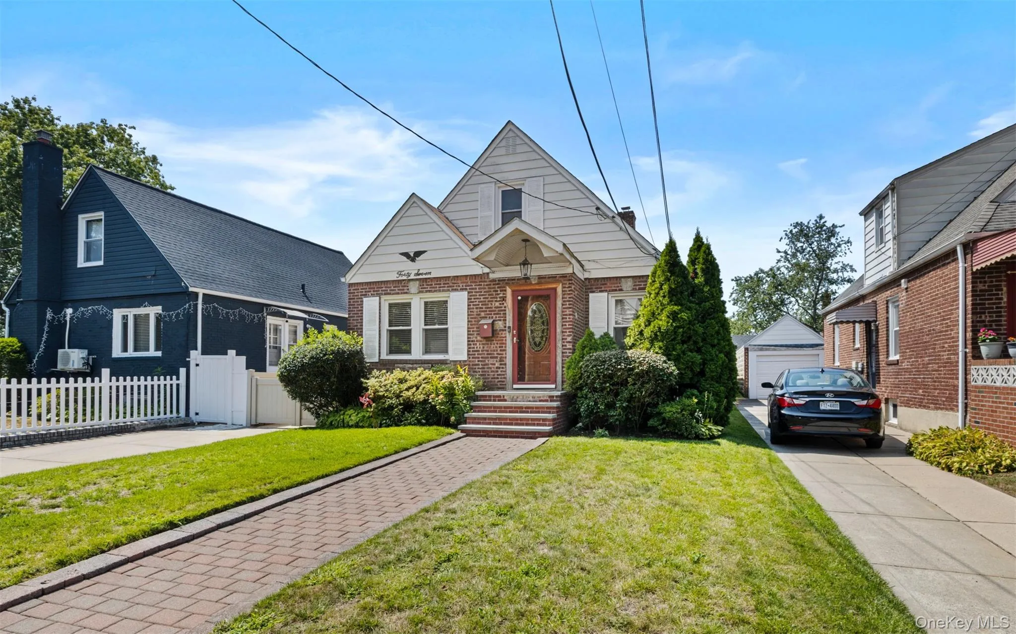Bungalow-style house featuring an outdoor structure, brick siding, a chimney, and a garage Bungalow-style house featuring an outdoor structure, brick siding, a chimney, and a garage