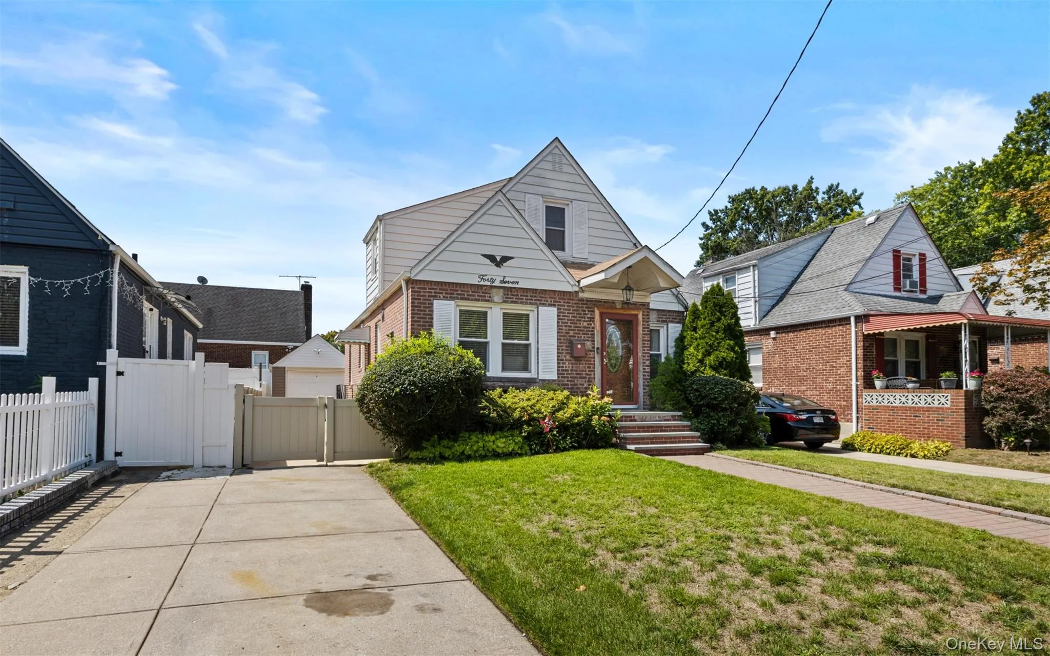 Bungalow with brick siding and a gate Bungalow with brick siding and a gate
