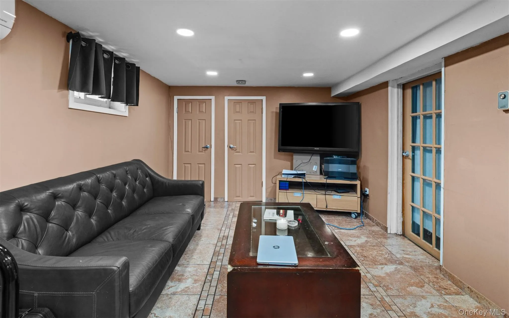 Living area featuring recessed lighting and an AC wall unit Living area featuring recessed lighting and an AC wall unit