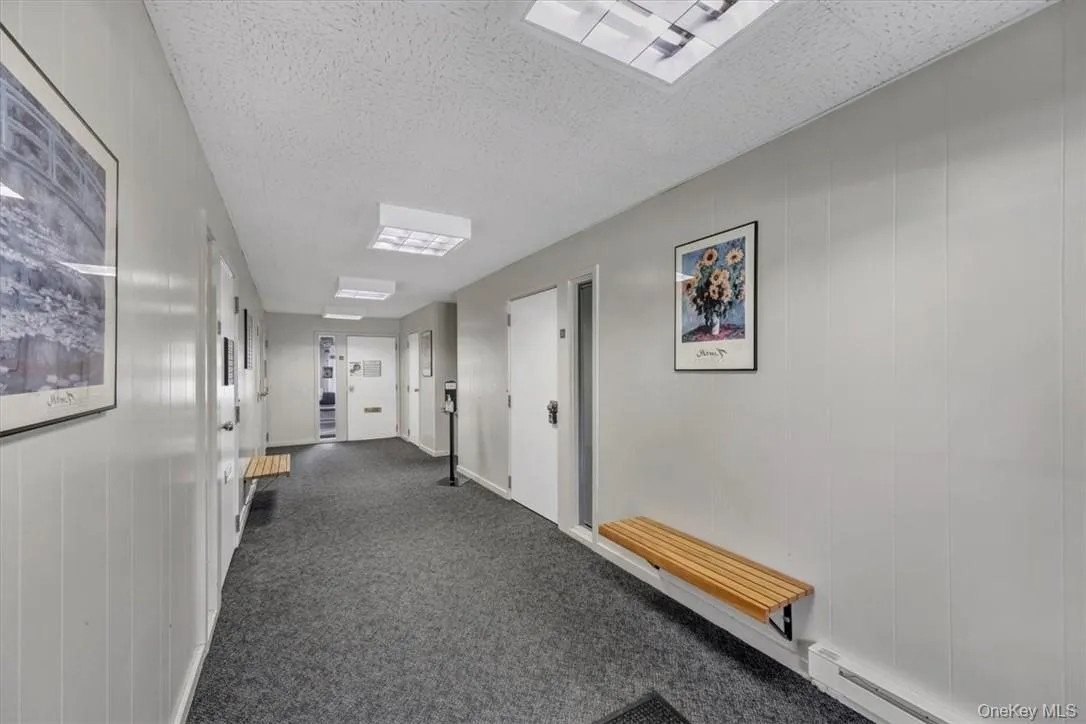 Clean and neat common hallway with sitting benches. Clean and neat common hallway with sitting benches.