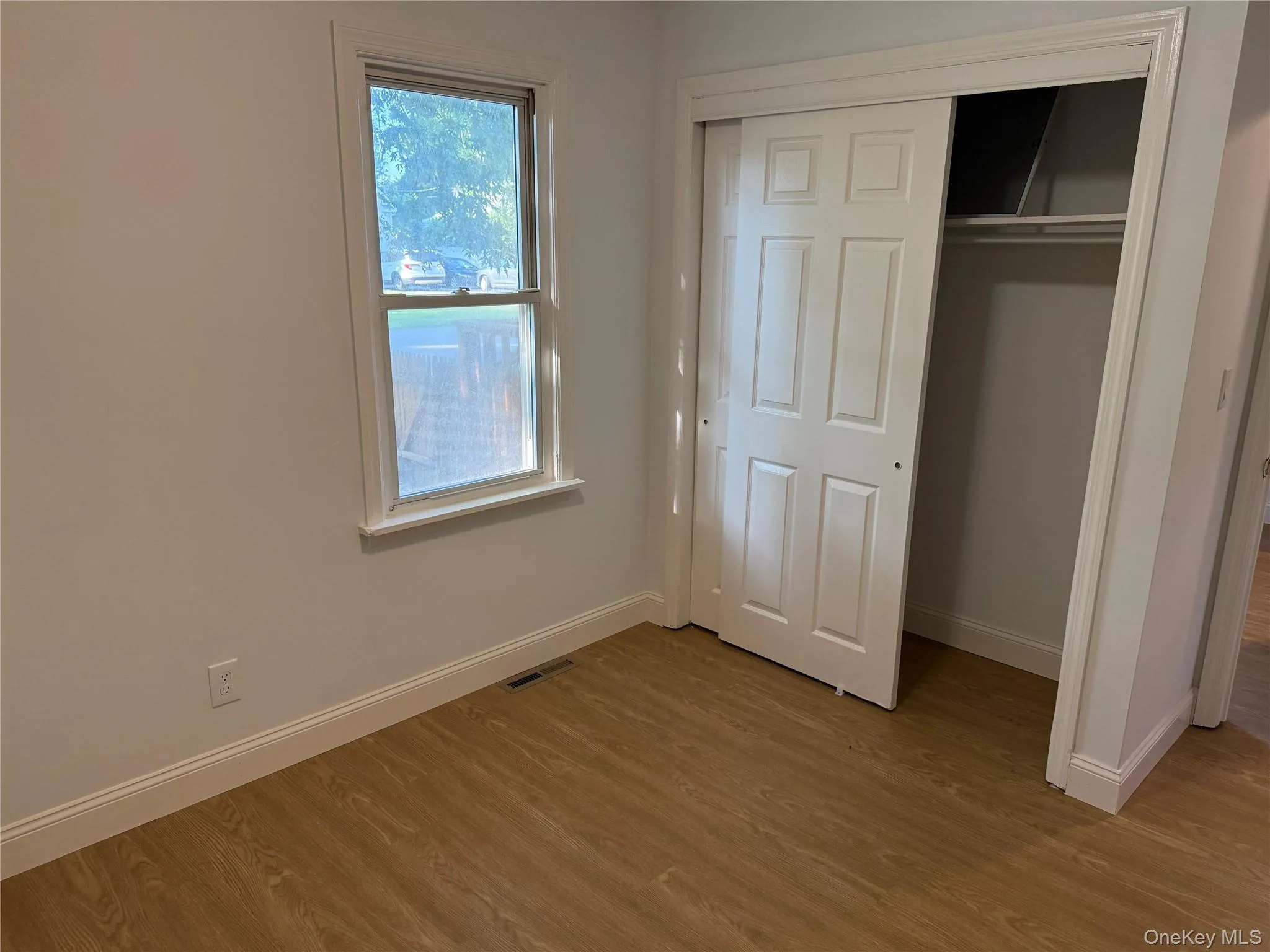 Unfurnished bedroom featuring light wood-style flooring and a closet Unfurnished bedroom featuring light wood-style flooring and a closet