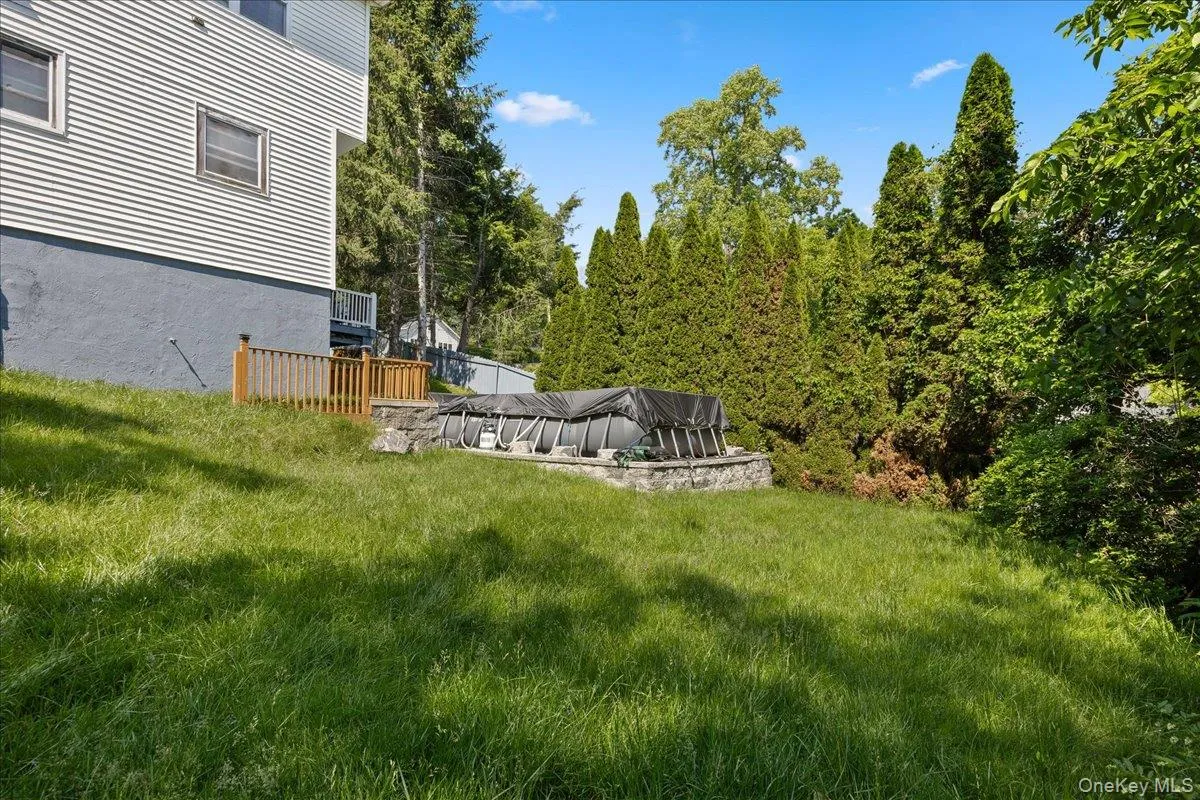 View of grassy yard with a patio area View of grassy yard with a patio area