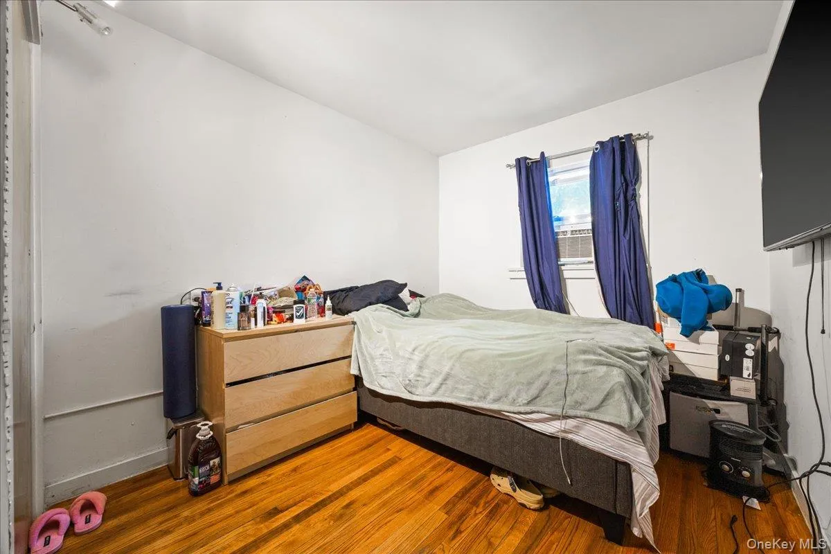 Bedroom with wood finished floors and lofted ceiling Bedroom with wood finished floors and lofted ceiling