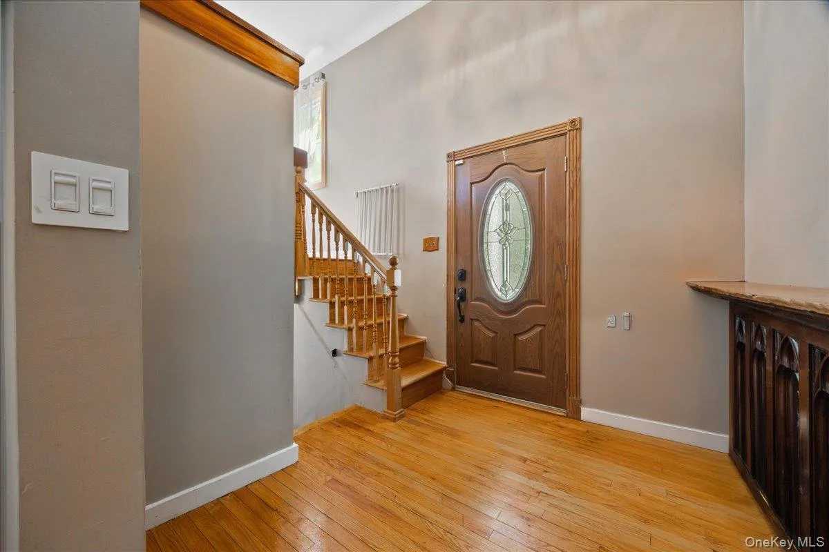 Entryway with baseboards and light wood-style flooring Entryway with baseboards and light wood-style flooring