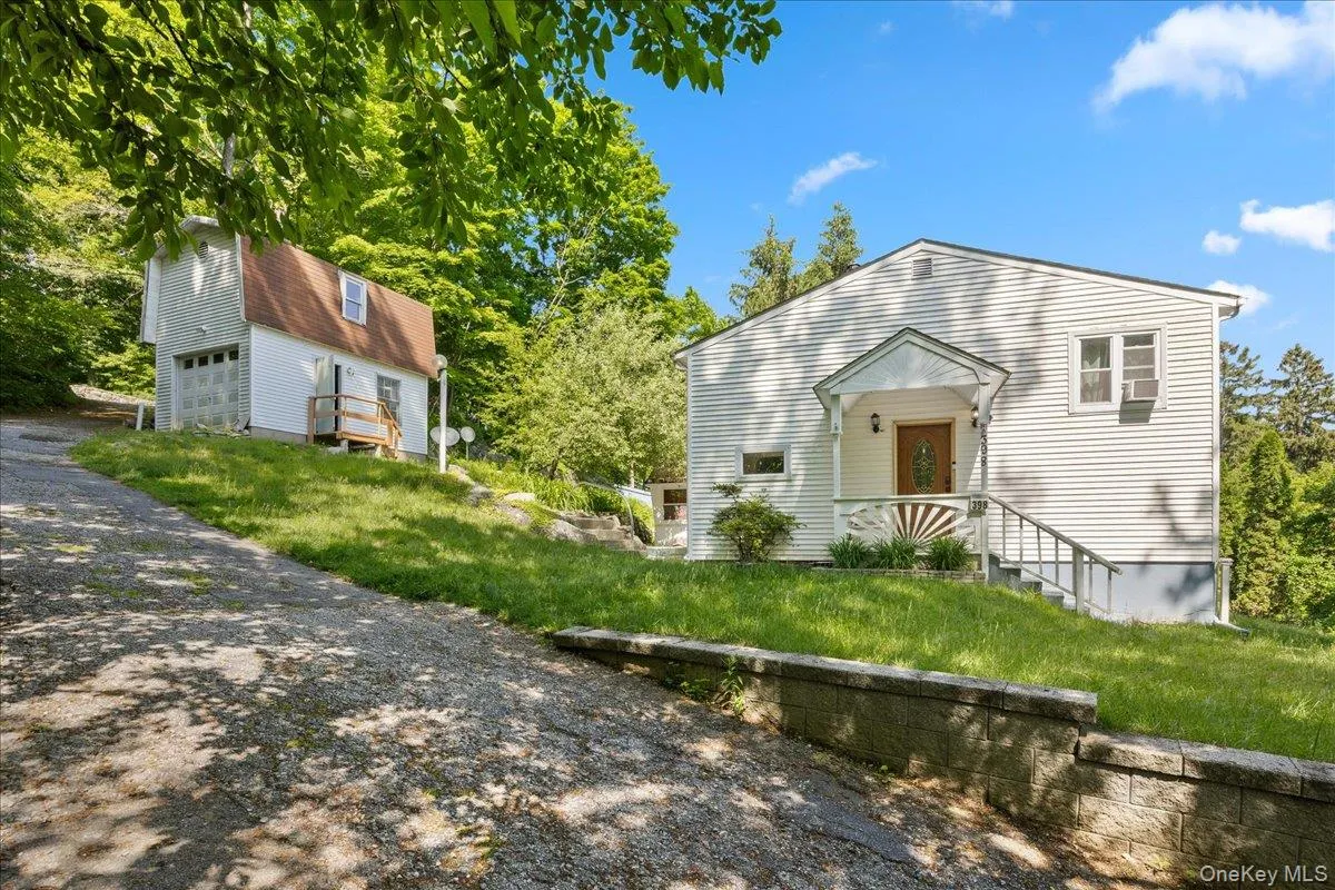 View of front of house featuring driveway and a front lawn View of front of house featuring driveway and a front lawn