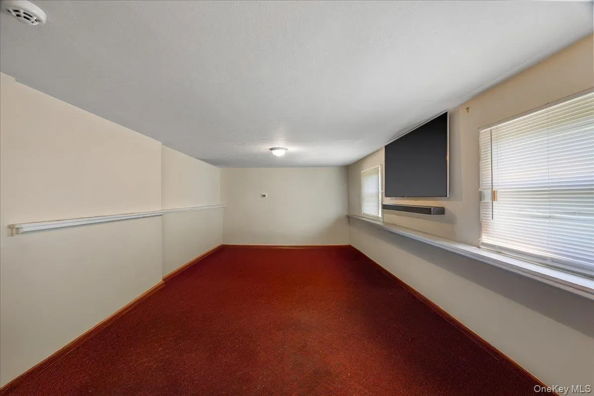 Carpeted empty room featuring baseboards Carpeted empty room featuring baseboards