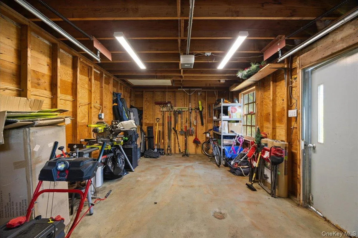 Garage with wooden walls and a garage door opener Garage with wooden walls and a garage door opener