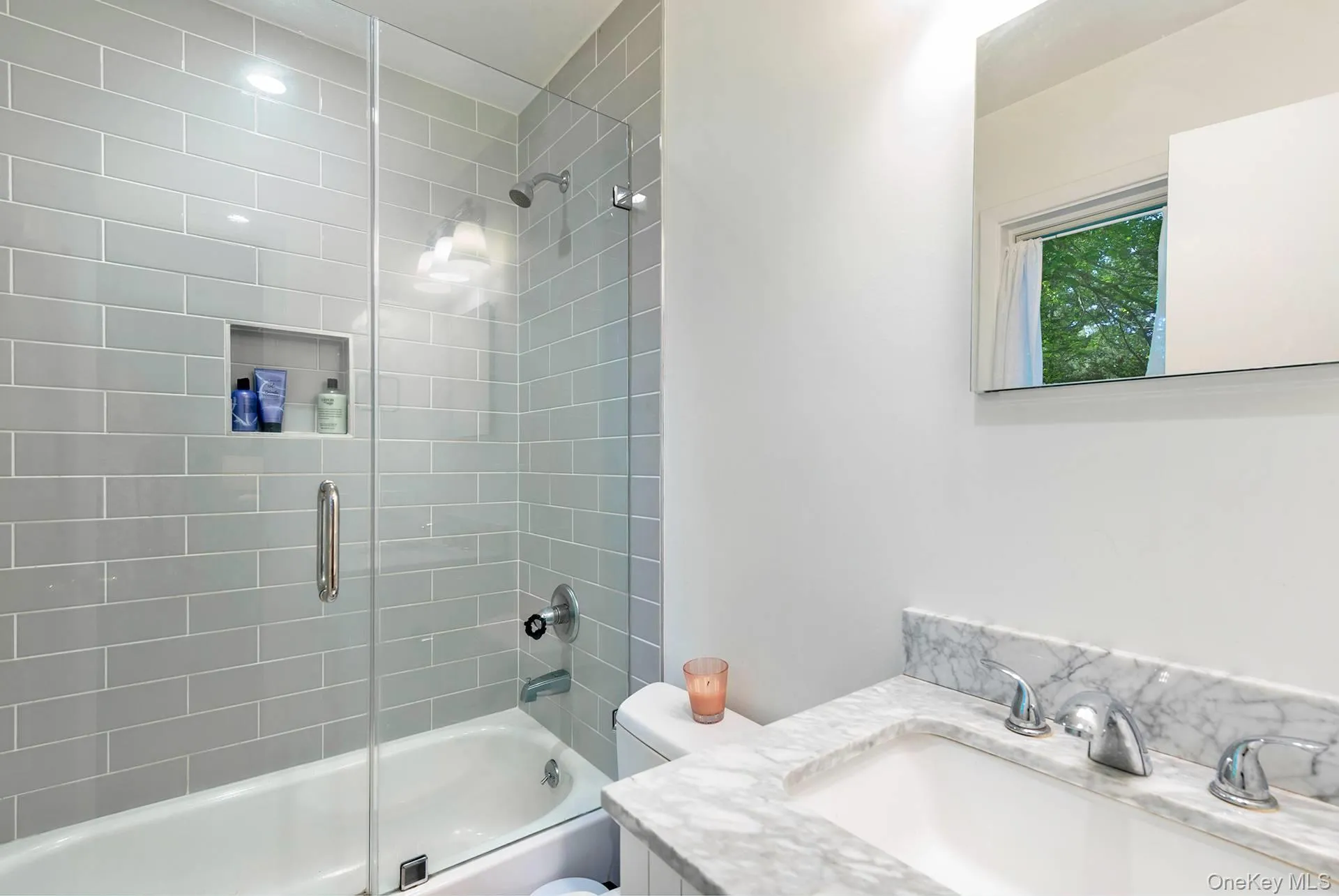 Full bathroom featuring combined bath / shower with glass door and vanity Full bathroom featuring combined bath / shower with glass door and vanity