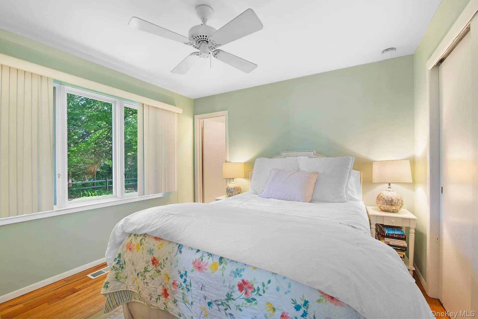 Bedroom with wood finished floors and a ceiling fan Bedroom with wood finished floors and a ceiling fan