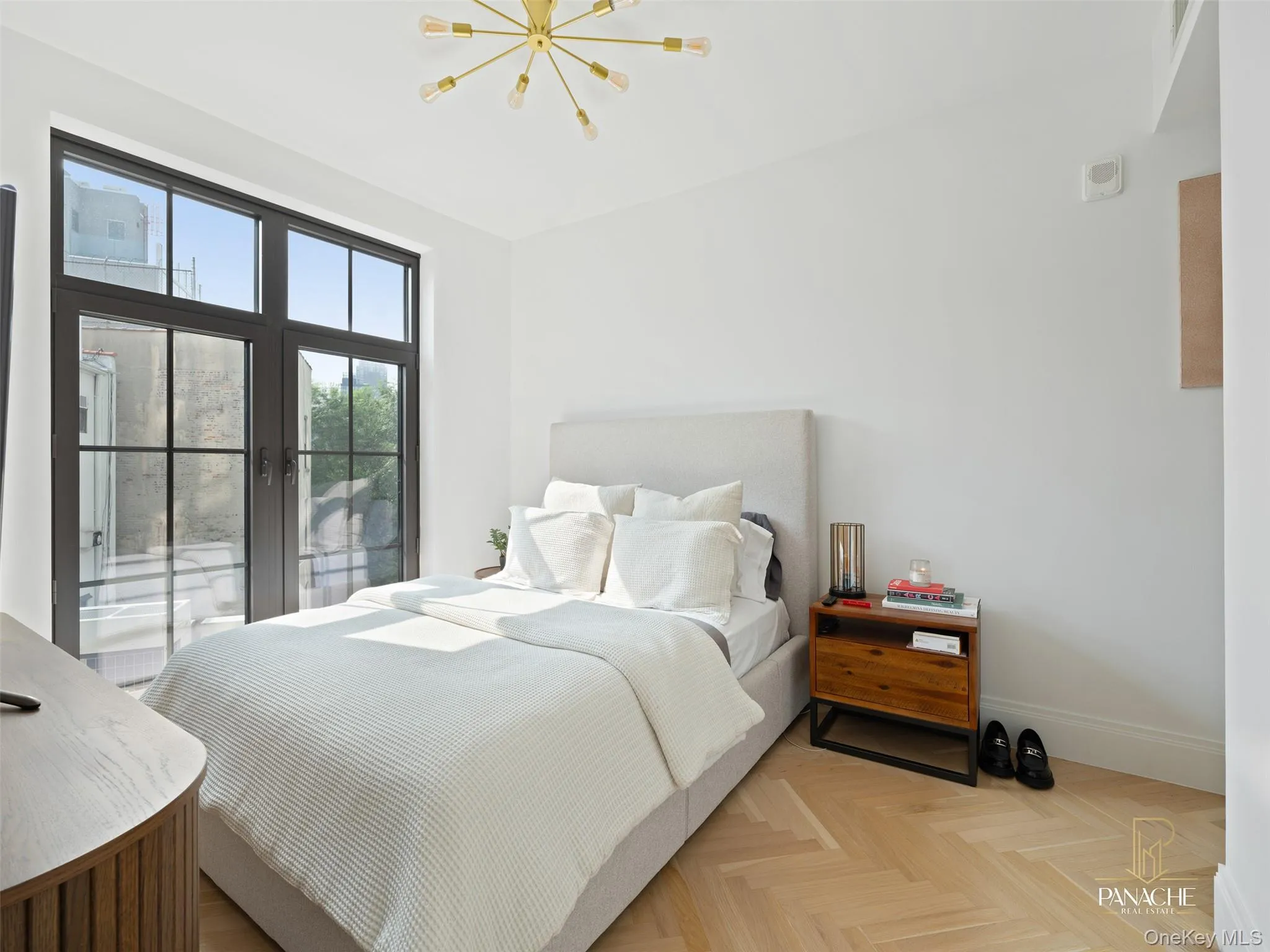 Bedroom featuring access to exterior and a chandelier Bedroom featuring access to exterior and a chandelier
