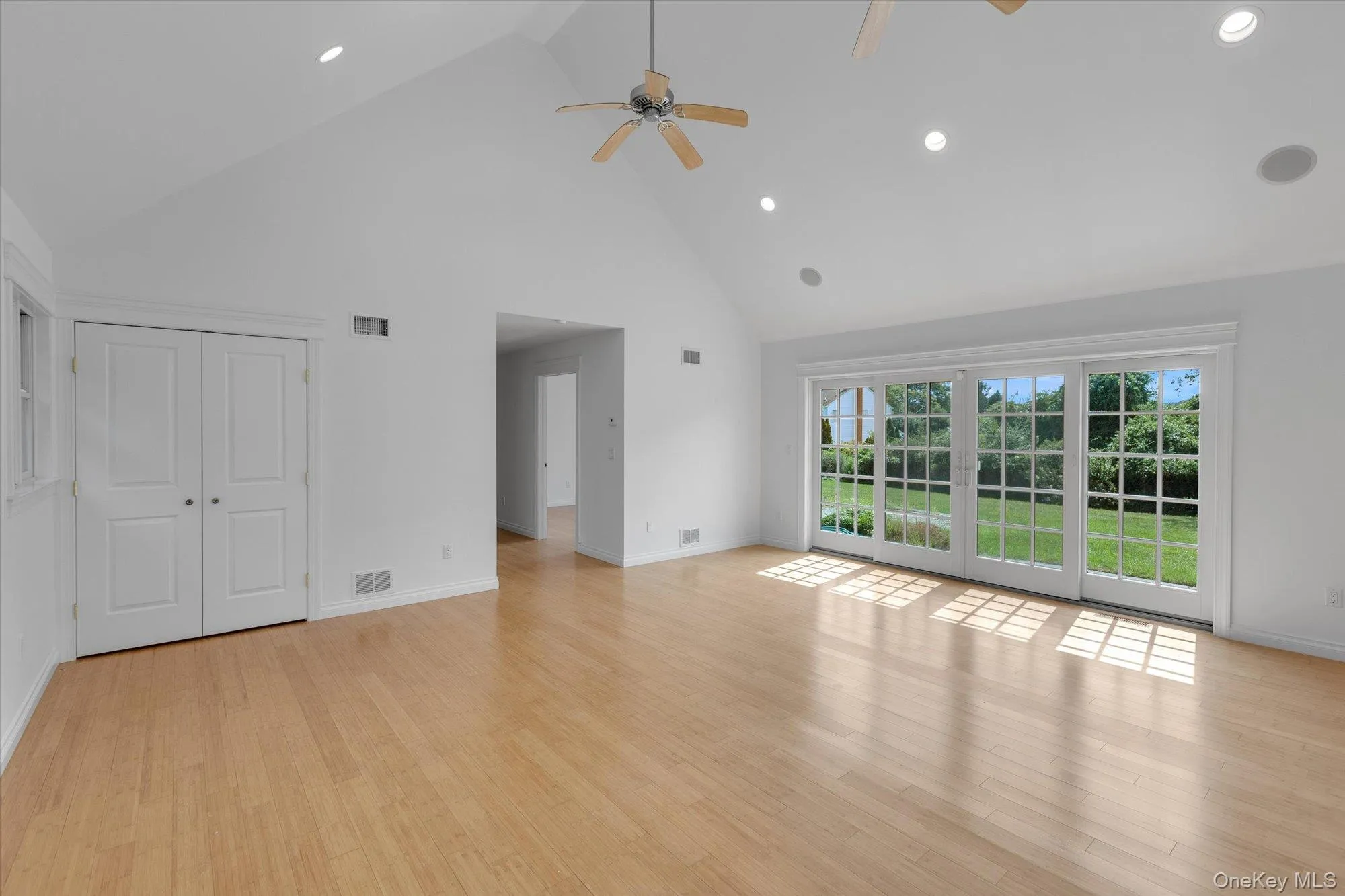 Unfurnished living room with high vaulted ceiling, recessed lighting, light wood-style floors, and ceiling fan Unfurnished living room with high vaulted ceiling, recessed lighting, light wood-style floors, and ceiling fan