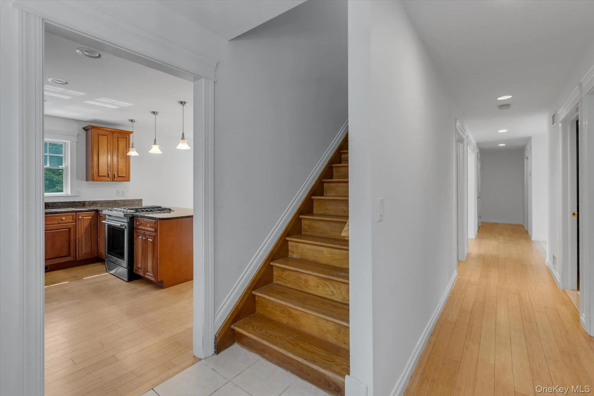 Stairway featuring recessed lighting and wood-type flooring Stairway featuring recessed lighting and wood-type flooring