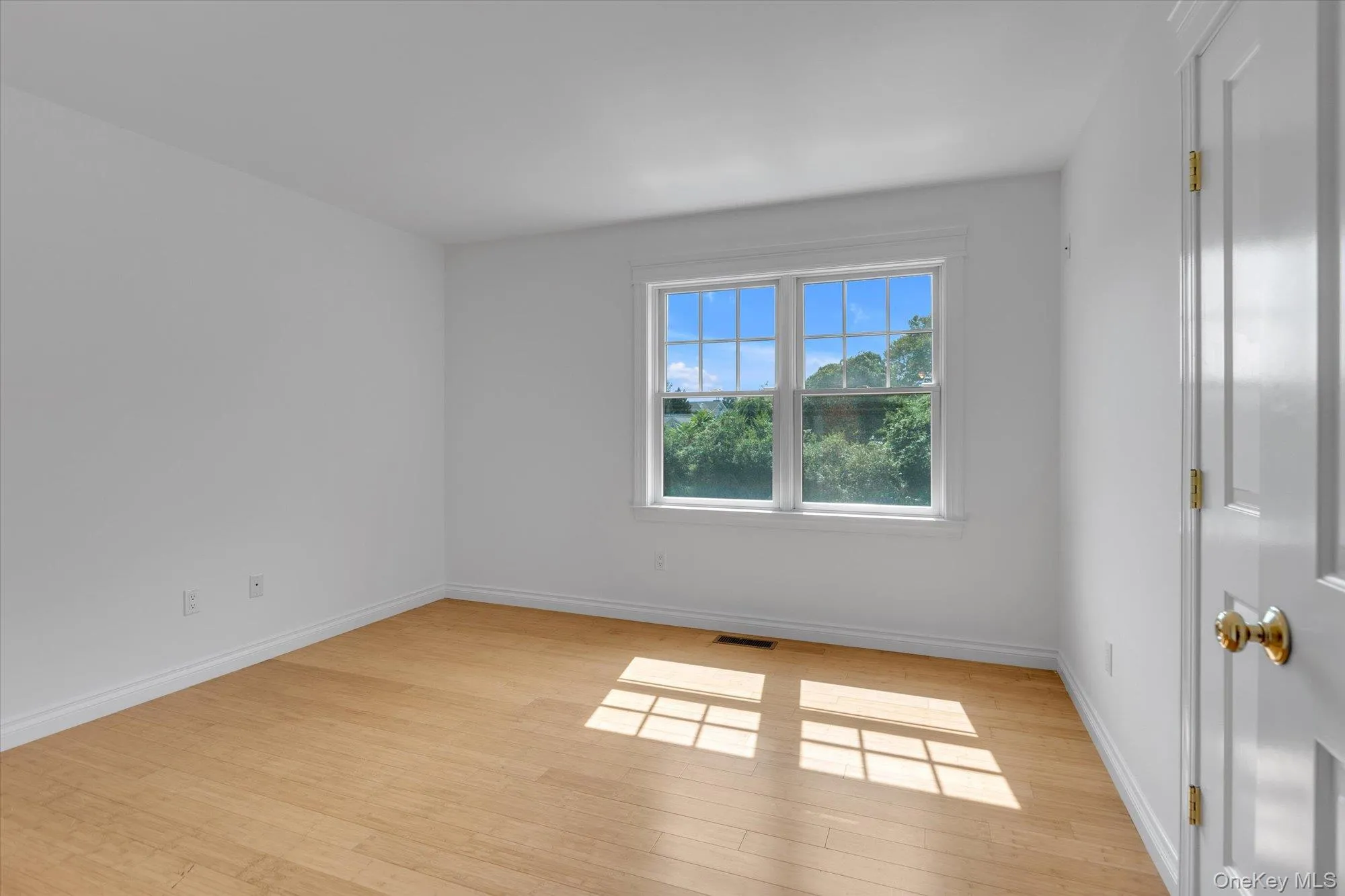Empty room featuring baseboards and light wood-type flooring Empty room featuring baseboards and light wood-type flooring