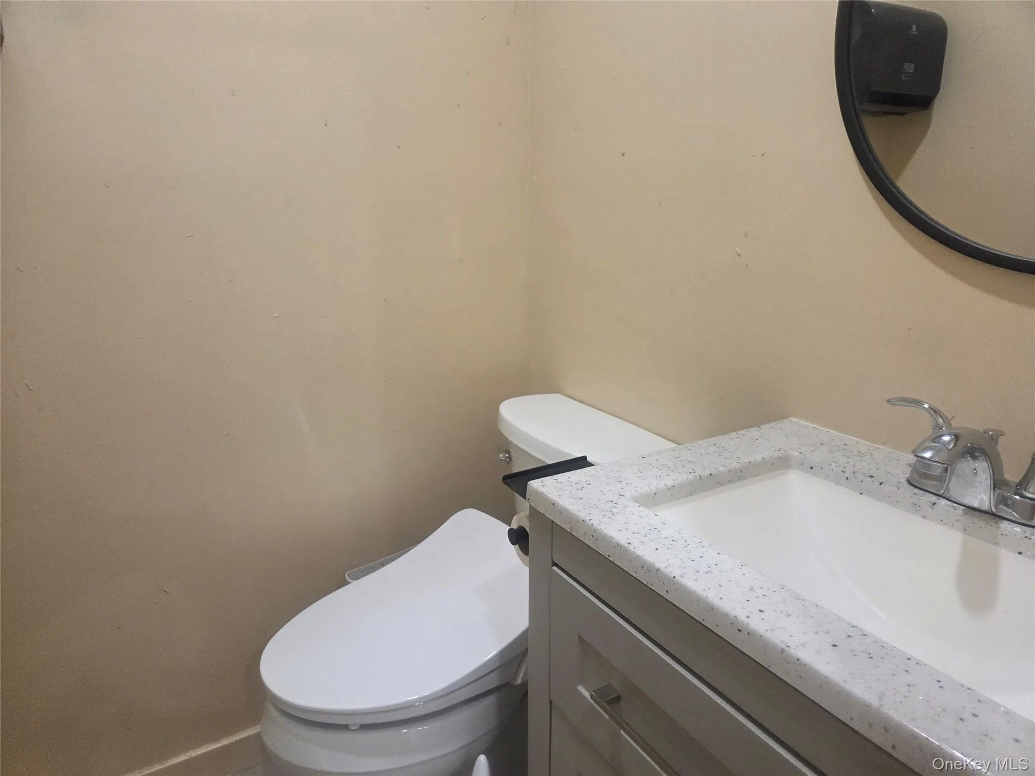 Bathroom featuring vanity and toilet Bathroom featuring vanity and toilet