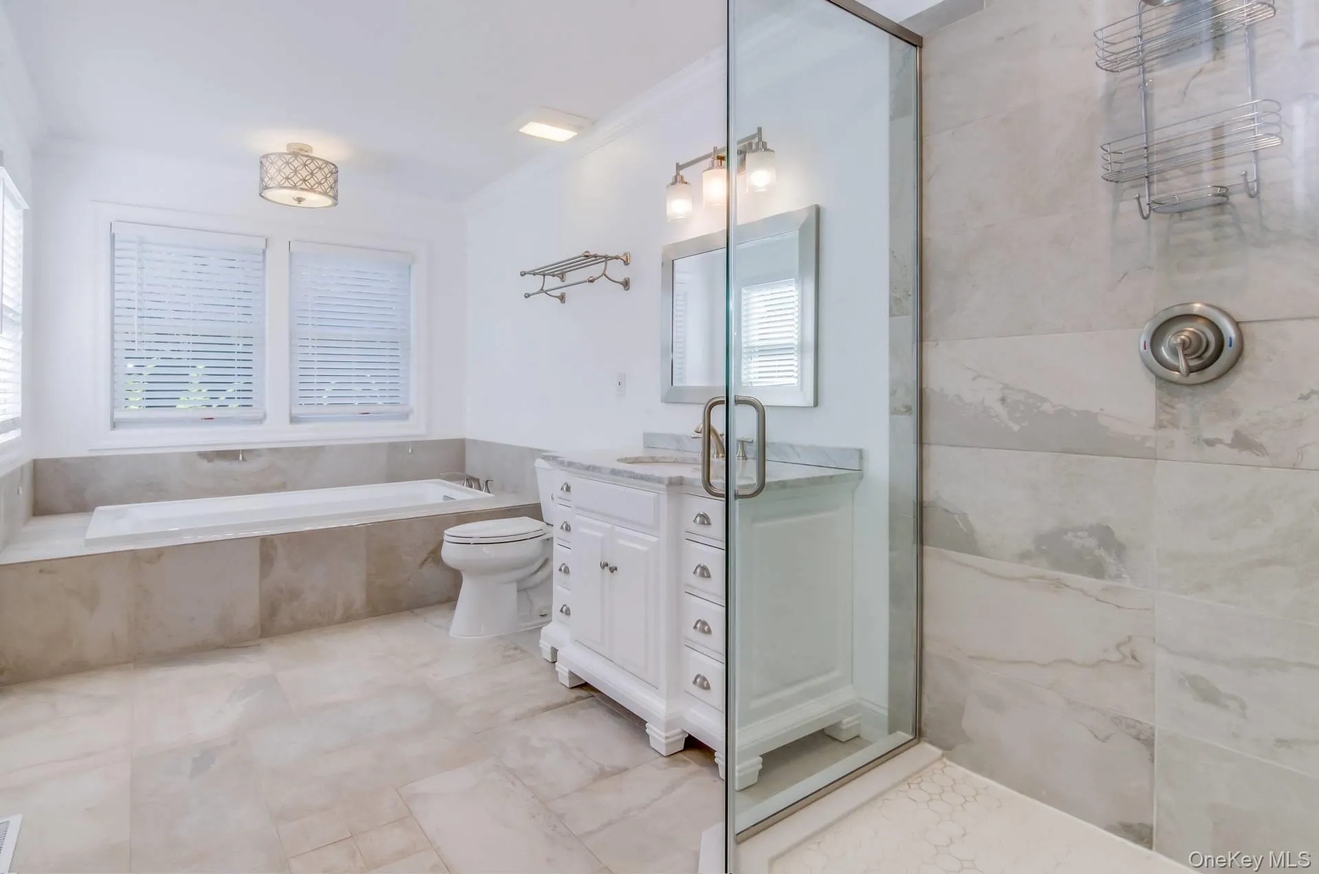 Full bathroom featuring vanity, a bath, crown molding, and tiled shower Full bathroom featuring vanity, a bath, crown molding, and tiled shower