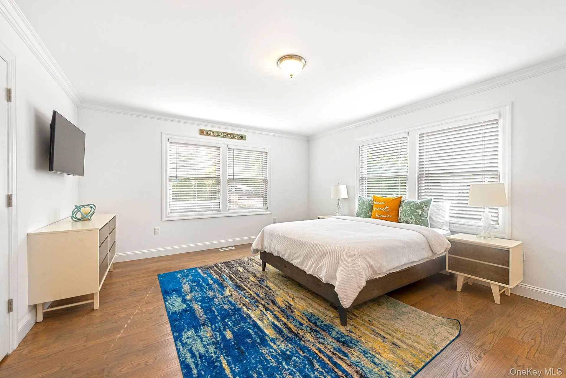 Bedroom featuring crown molding and dark wood-type flooring Bedroom featuring crown molding and dark wood-type flooring