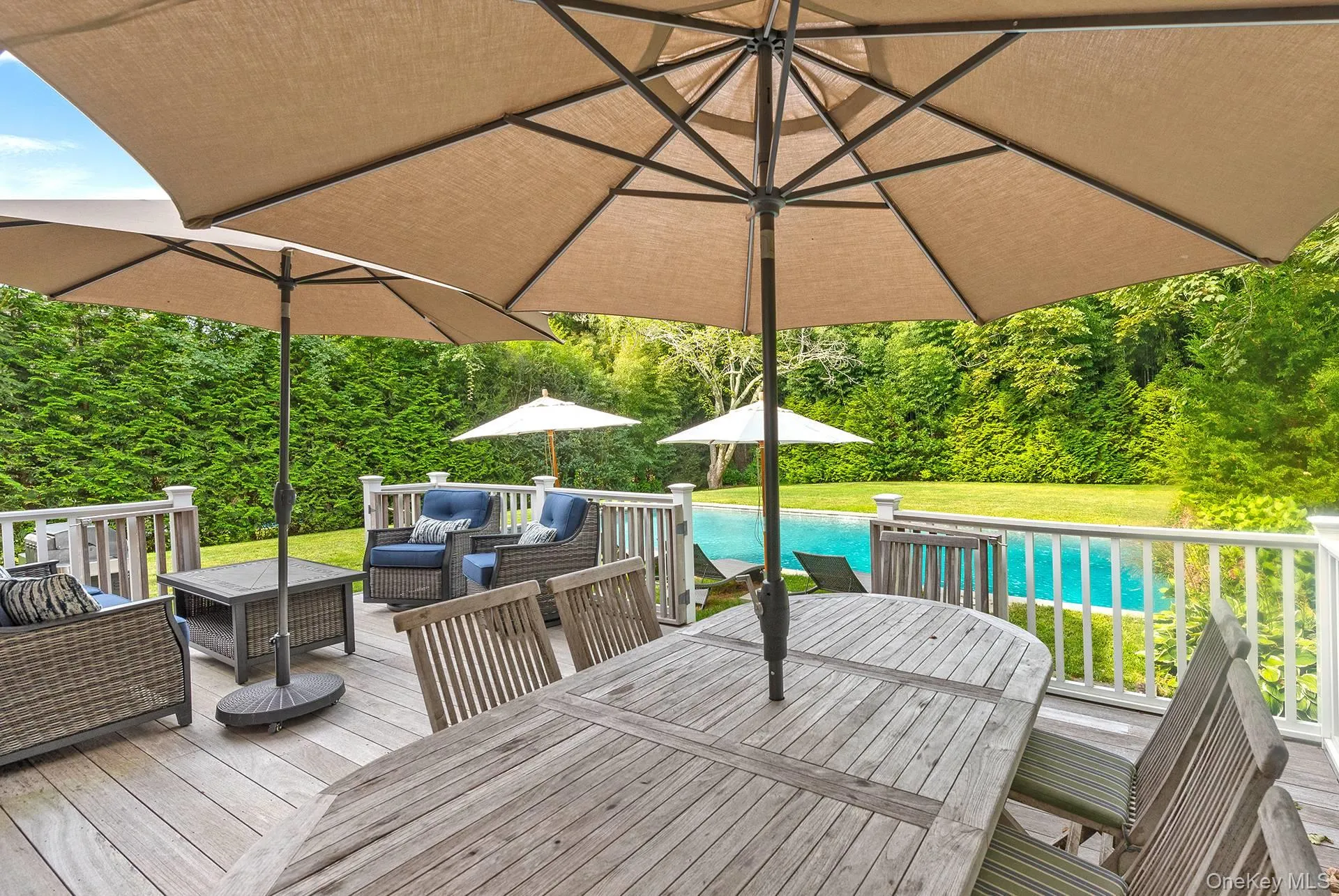 Deck featuring an outdoor hangout area, an outdoor pool, outdoor dining area, and a yard Deck featuring an outdoor hangout area, an outdoor pool, outdoor dining area, and a yard