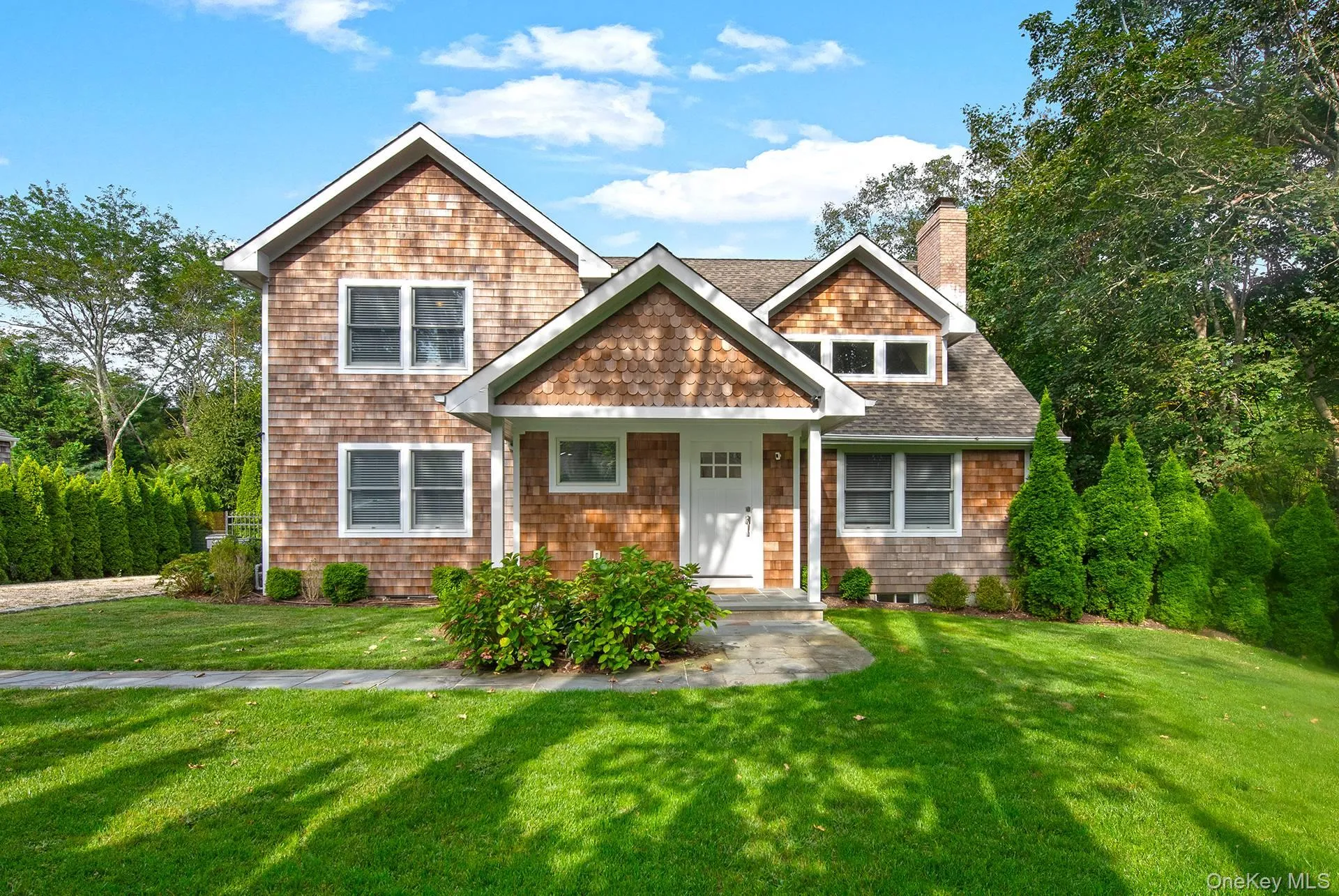 View of front of house featuring a front lawn, roof with shingles, and a chimney View of front of house featuring a front lawn, roof with shingles, and a chimney
