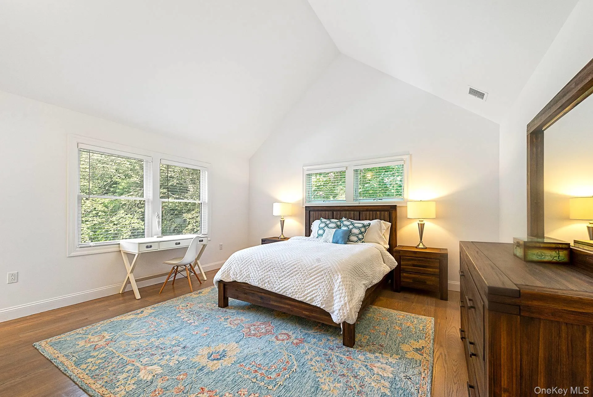 Bedroom with high vaulted ceiling and dark wood-type flooring Bedroom with high vaulted ceiling and dark wood-type flooring