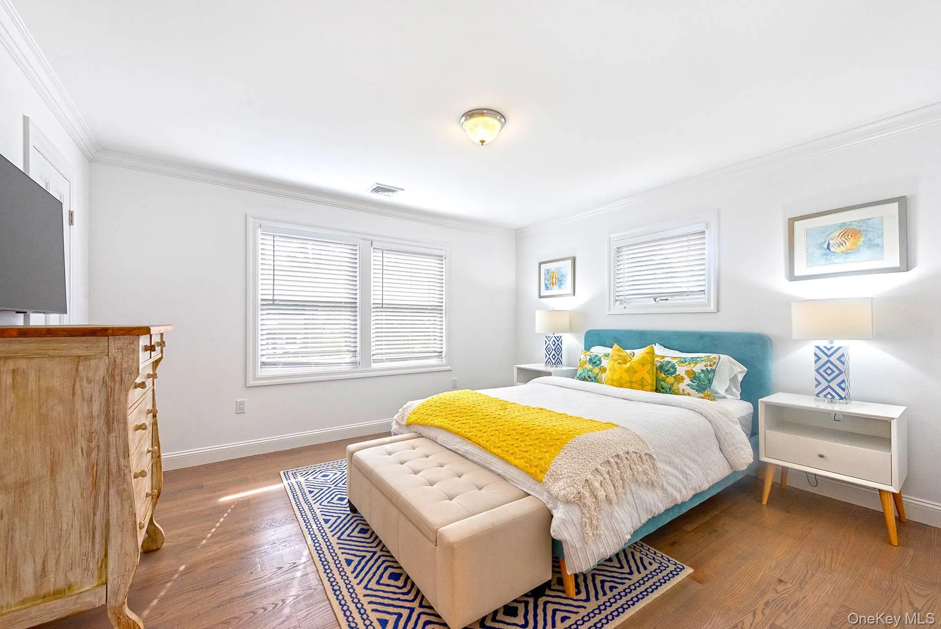 Bedroom featuring dark wood finished floors and ornamental molding Bedroom featuring dark wood finished floors and ornamental molding