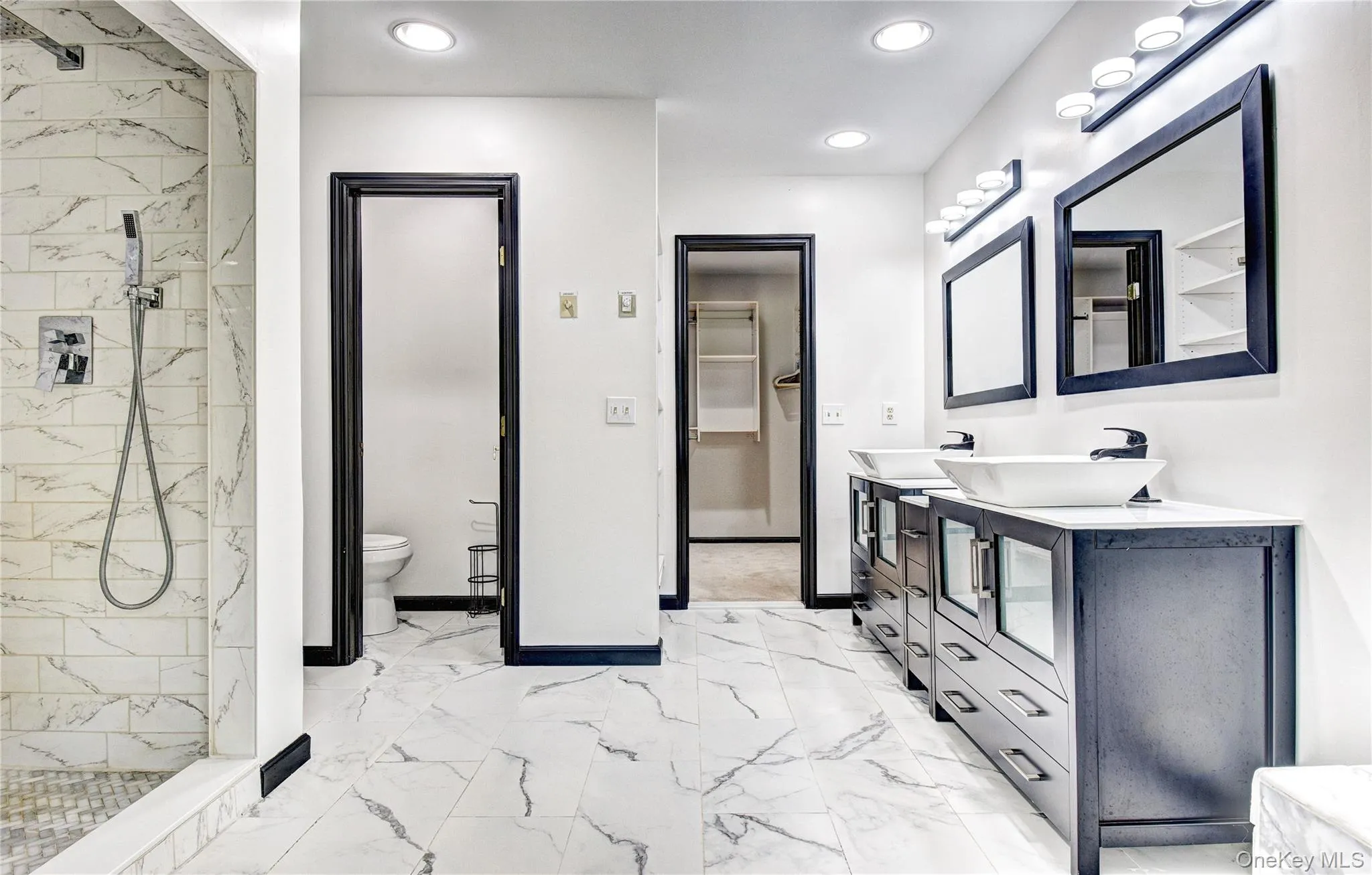 Double vanity, private toilet area, walk-in shower and jacuzzi in the primary bathroom ensuite Double vanity, private toilet area, walk-in shower and jacuzzi in the primary bathroom ensuite