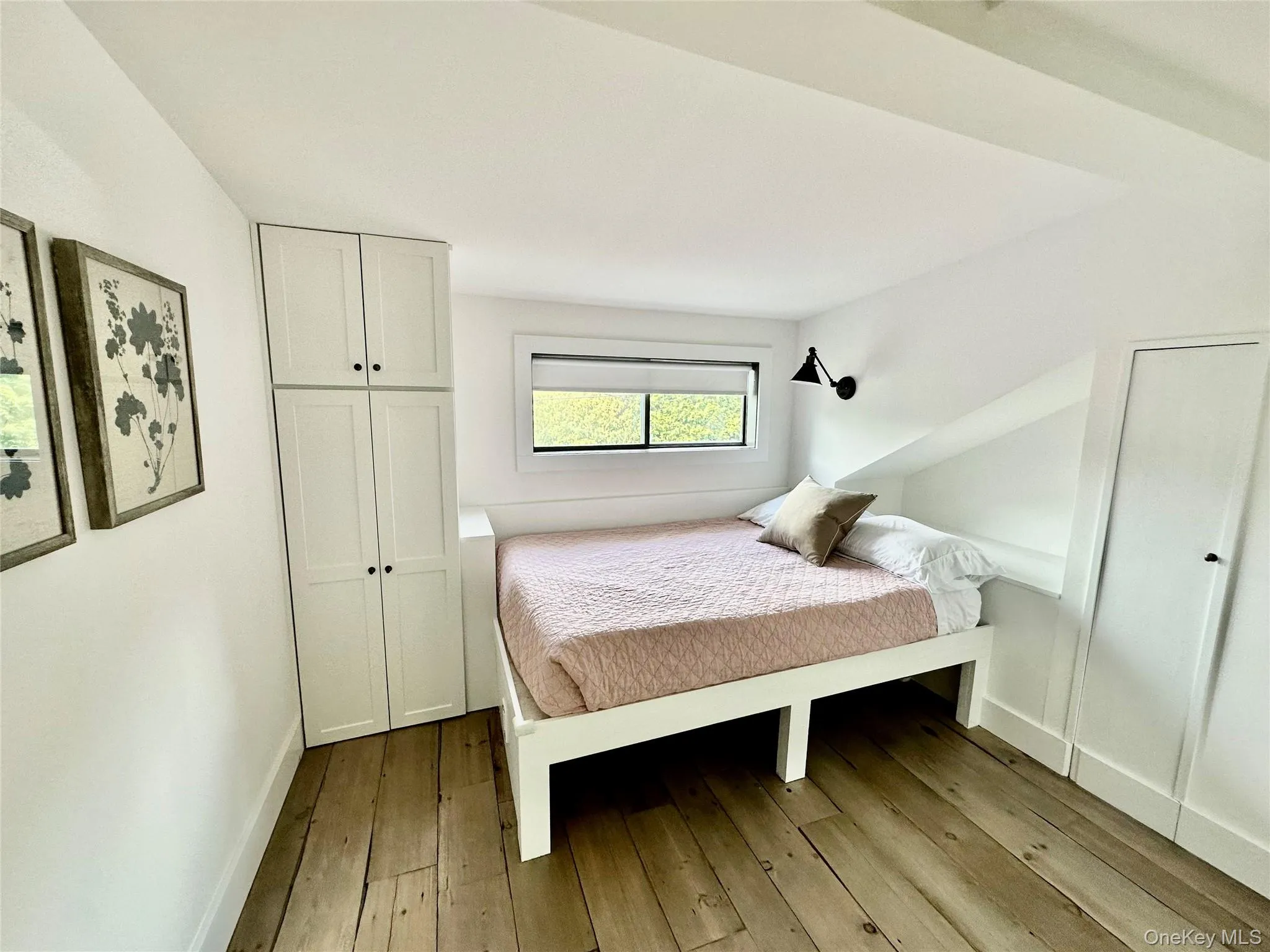 Bedroom with light wood-style flooring and baseboards Bedroom with light wood-style flooring and baseboards