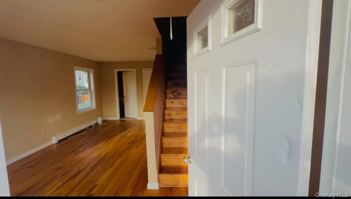 Stairway featuring wood finished floors and baseboards Stairway featuring wood finished floors and baseboards