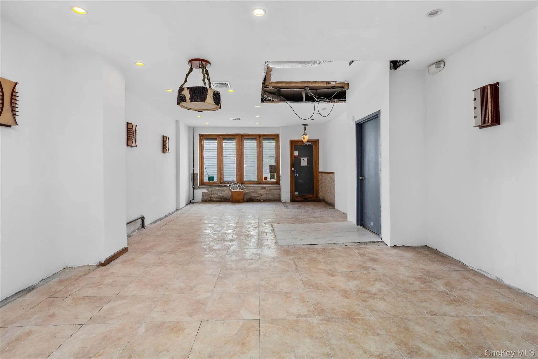 Empty room featuring recessed lighting and light tile patterned flooring Empty room featuring recessed lighting and light tile patterned flooring