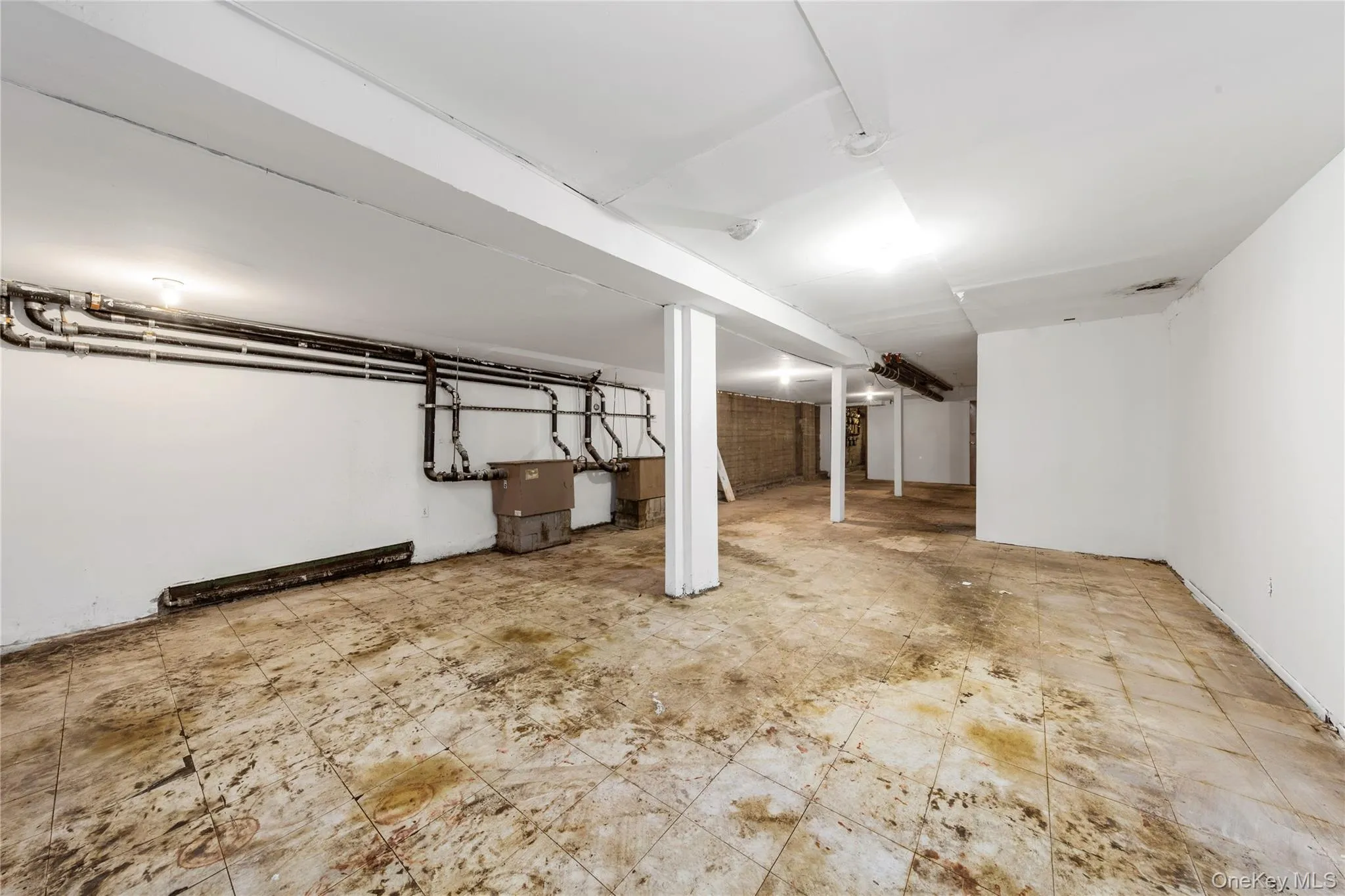 Finished below grade area featuring light floors Finished below grade area featuring light floors