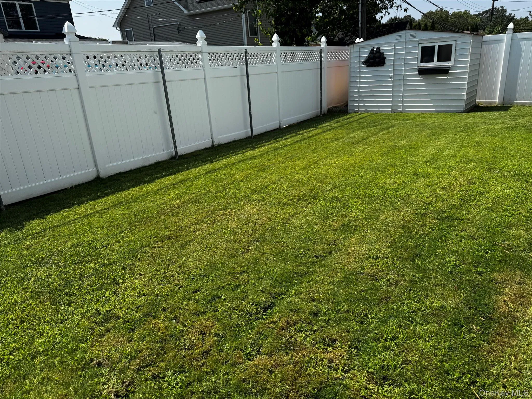 Fenced backyard featuring a shed Fenced backyard featuring a shed