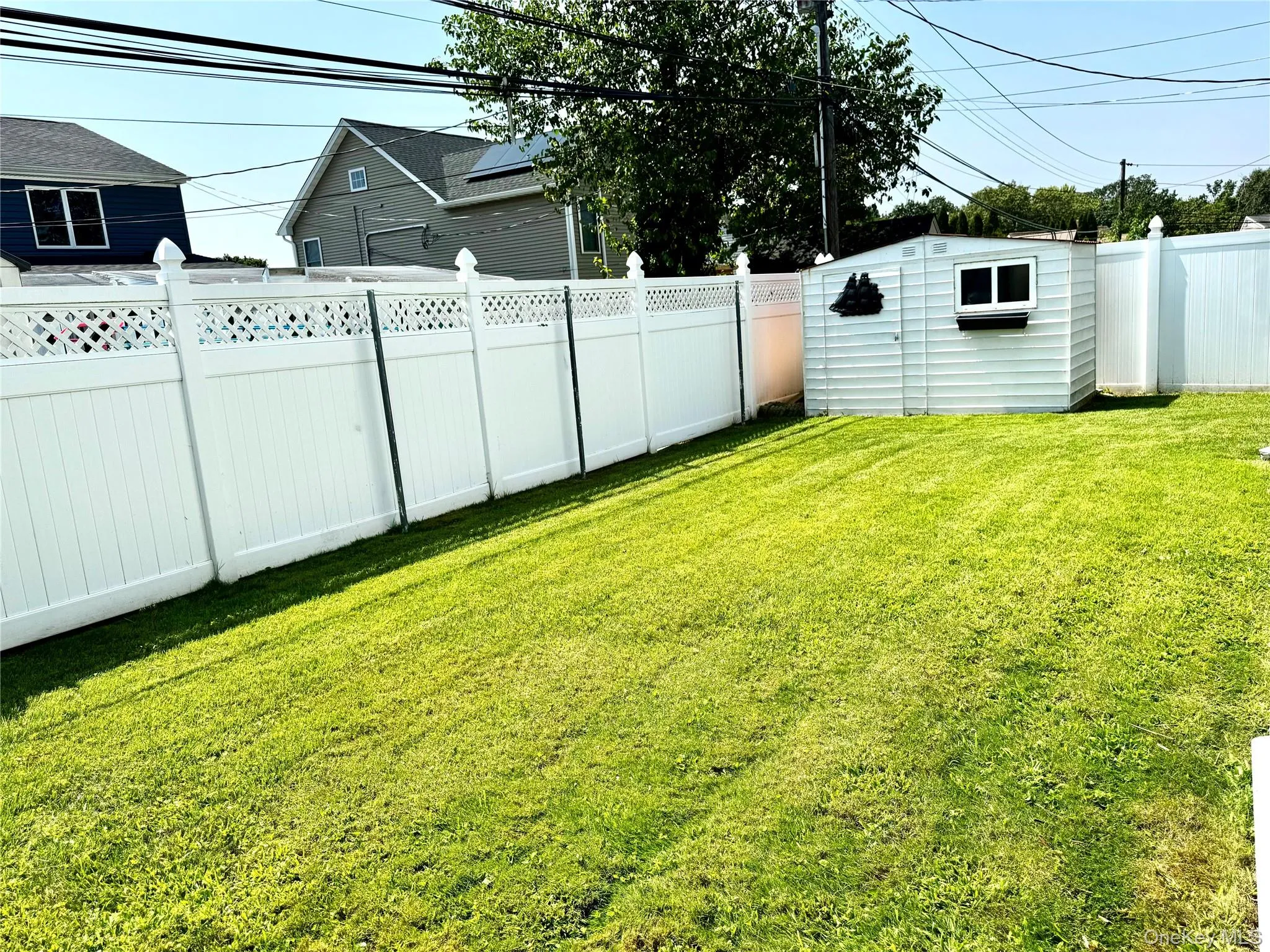Fenced backyard with a shed Fenced backyard with a shed