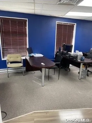 Office with a drop ceiling and light wood-style flooring Office with a drop ceiling and light wood-style flooring