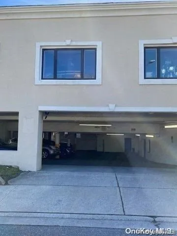 View of side of property with stucco siding, a garage, and concrete driveway View of side of property with stucco siding, a garage, and concrete driveway