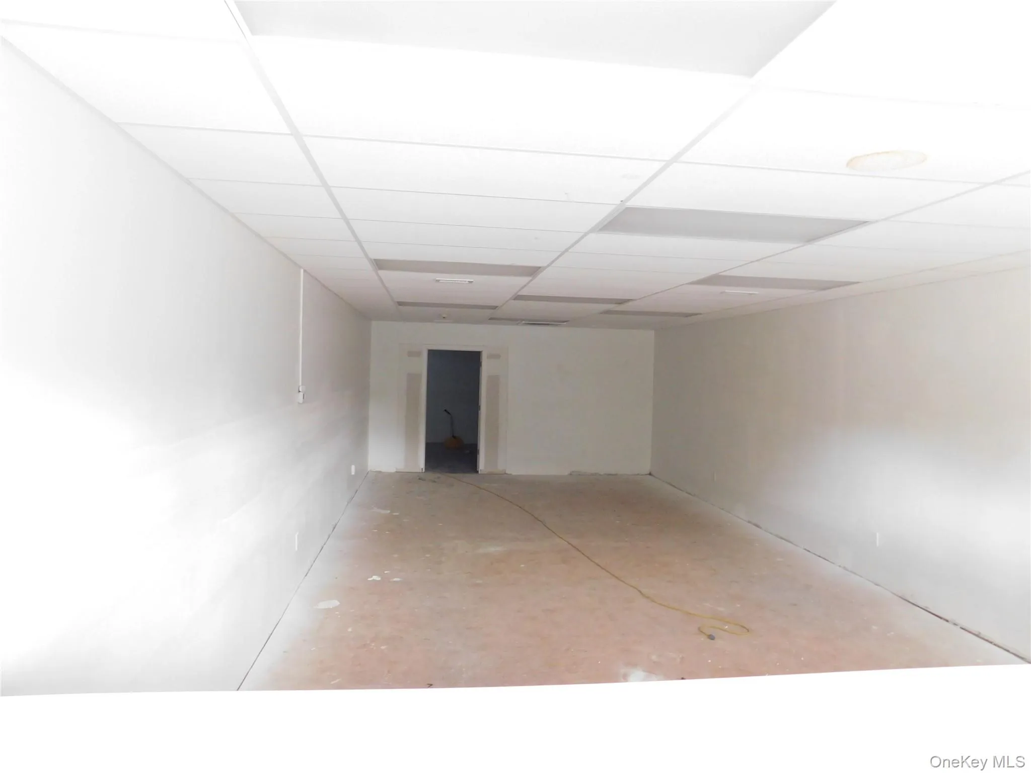 Unfurnished room with a paneled ceiling Unfurnished room with a paneled ceiling