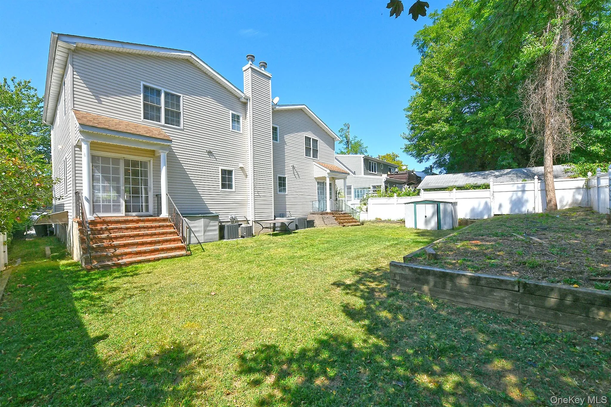 Back of property featuring a chimney and a garden Back of property featuring a chimney and a garden