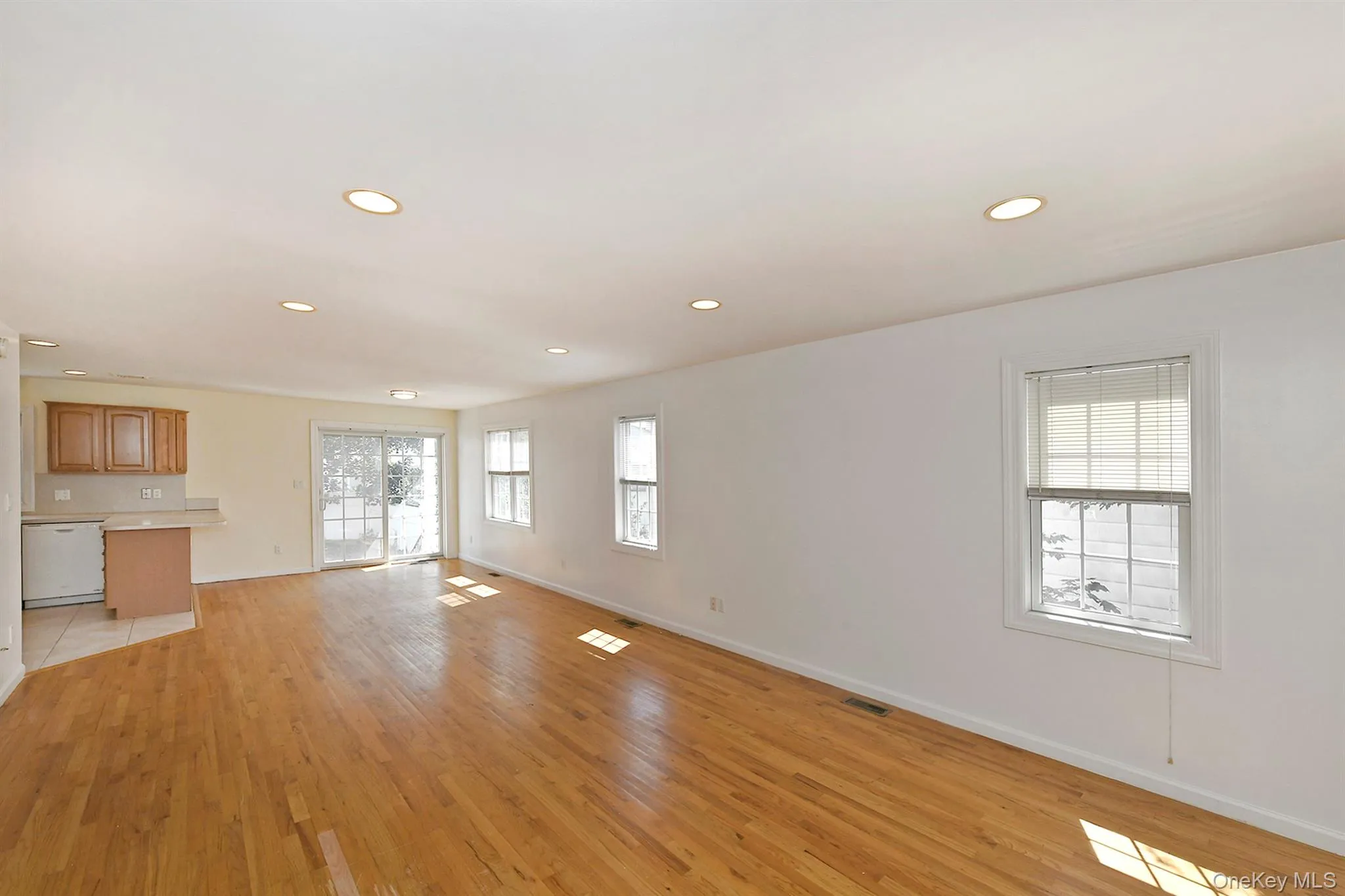 Unfurnished living room with light wood-style floors and recessed lighting Unfurnished living room with light wood-style floors and recessed lighting
