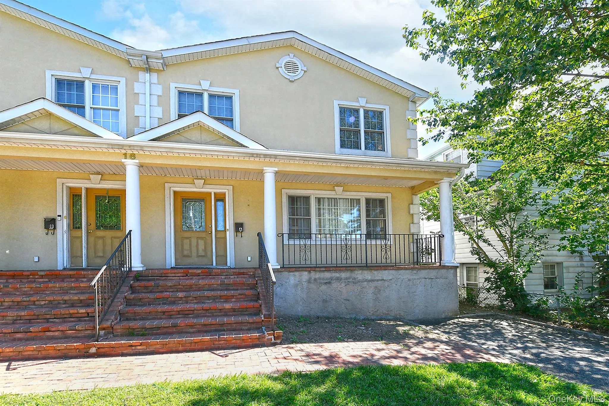 View of front facade with stucco siding and a porch View of front facade with stucco siding and a porch