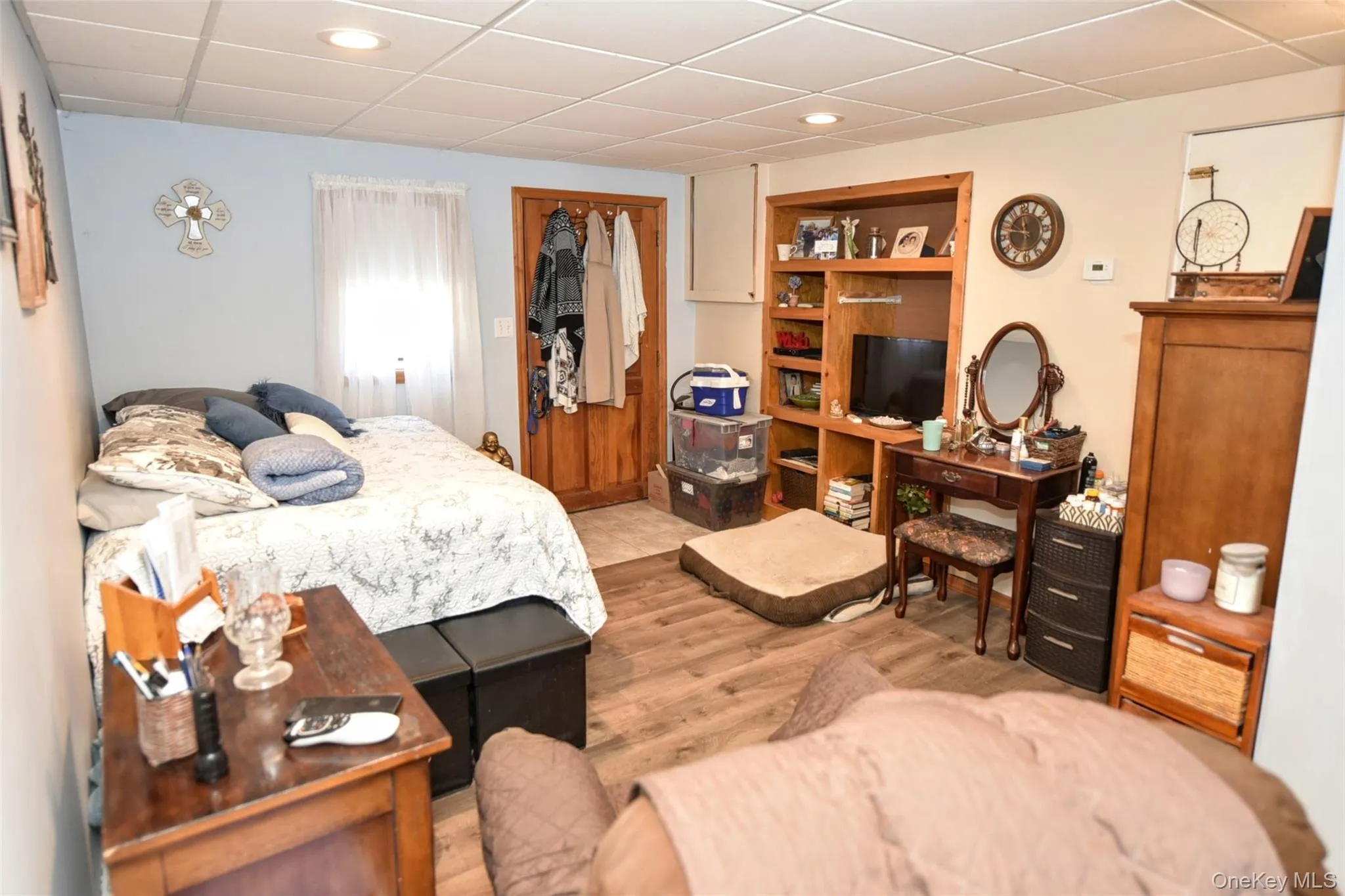Bedroom with a paneled ceiling, wood finished floors, a closet, and recessed lighting Bedroom with a paneled ceiling, wood finished floors, a closet, and recessed lighting