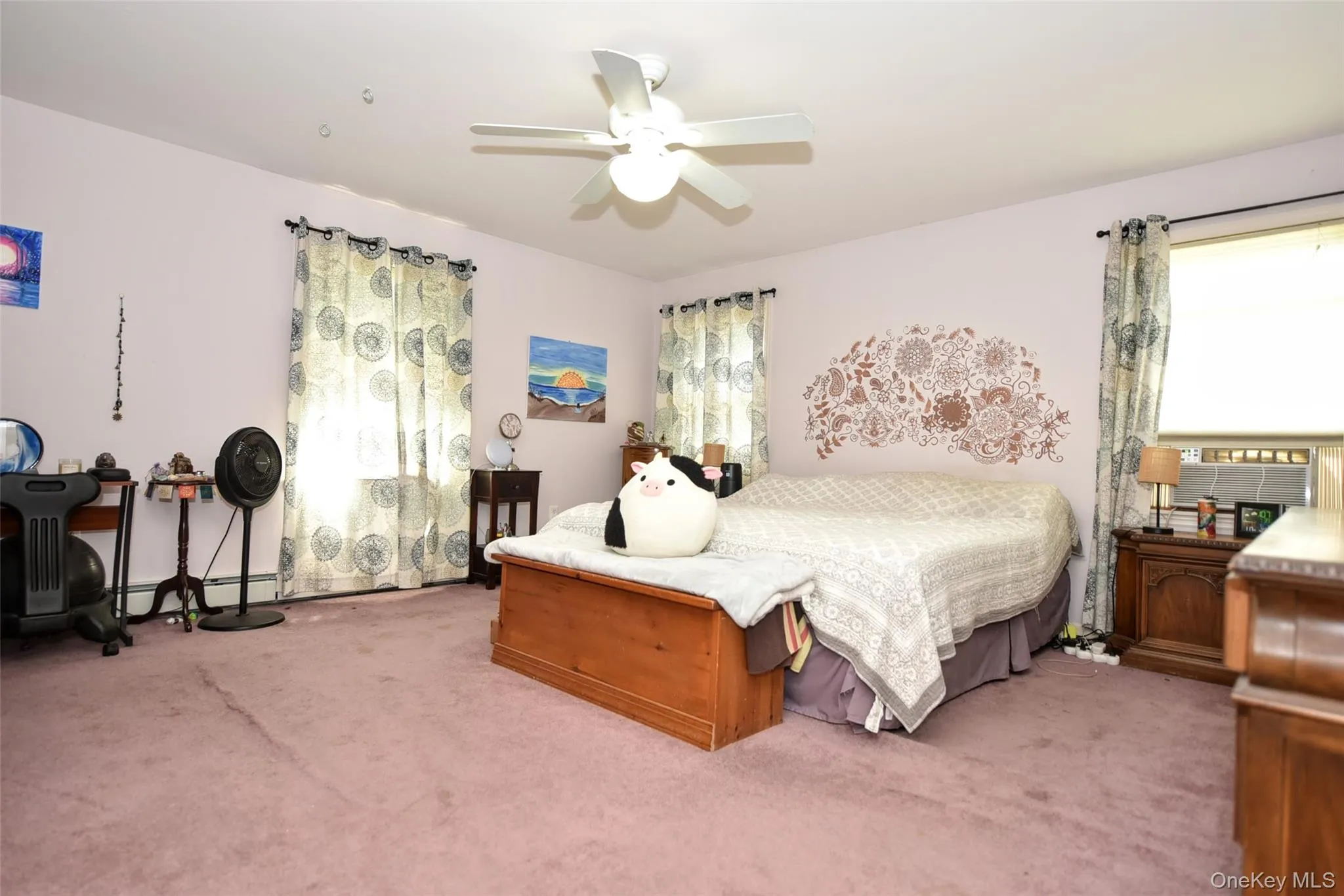 Bedroom featuring light carpet and a ceiling fan Bedroom featuring light carpet and a ceiling fan
