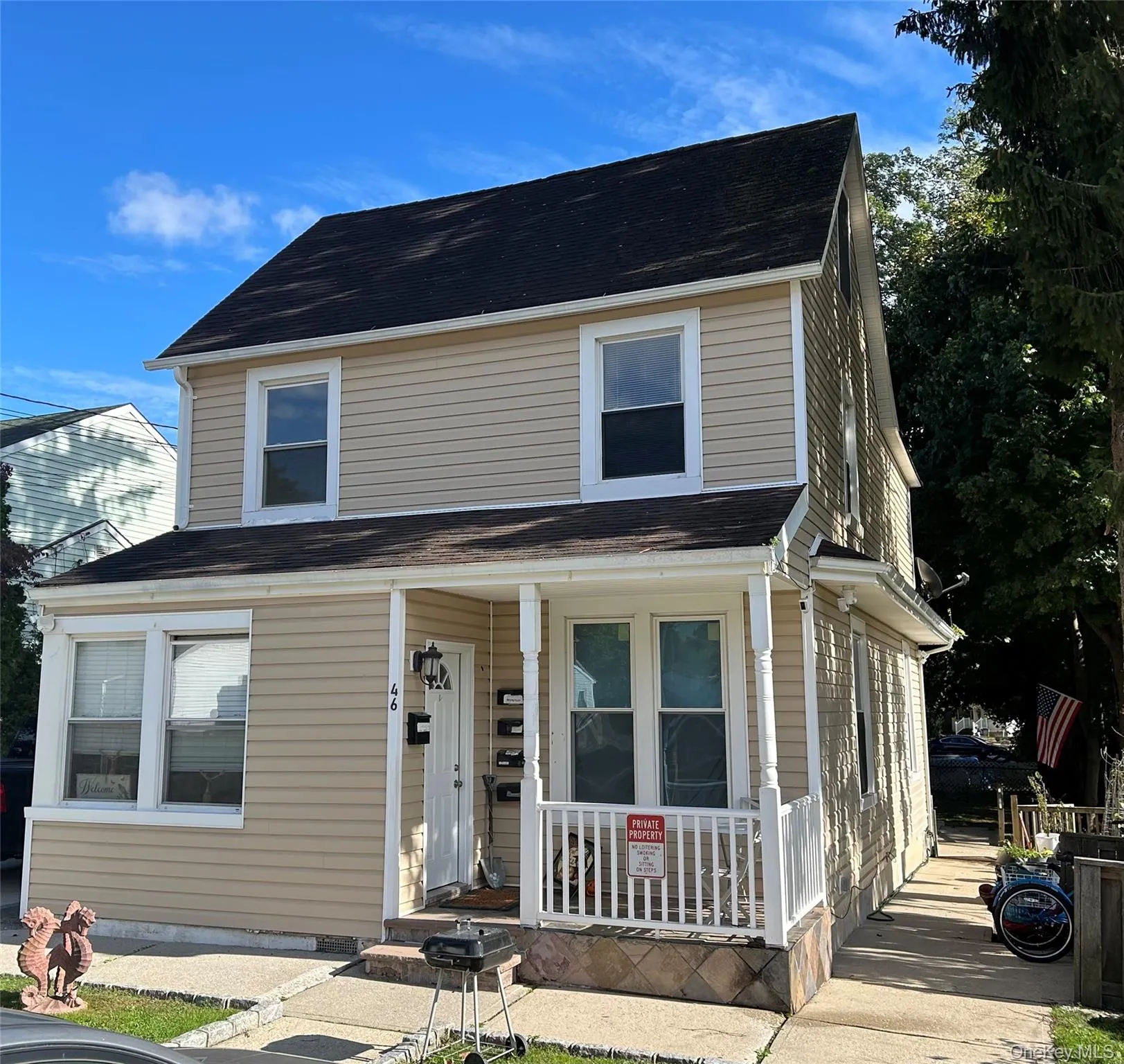 View of front facade featuring covered porch and a shingled roof View of front facade featuring covered porch and a shingled roof