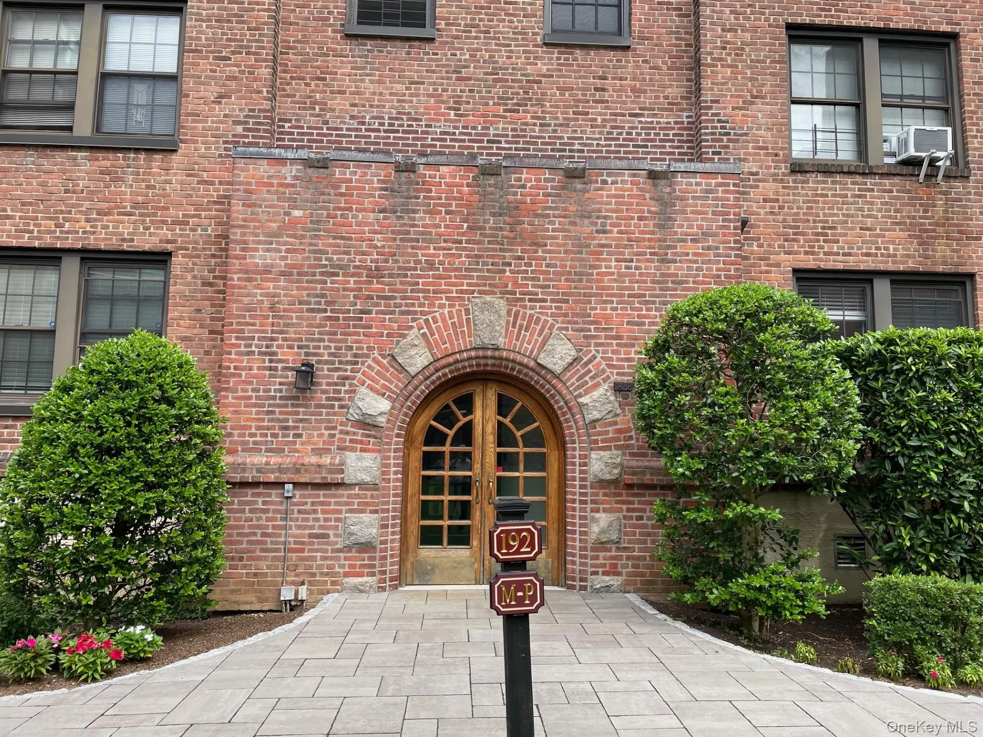 View of exterior entry featuring brick siding, a patio area, and french doors View of exterior entry featuring brick siding, a patio area, and french doors