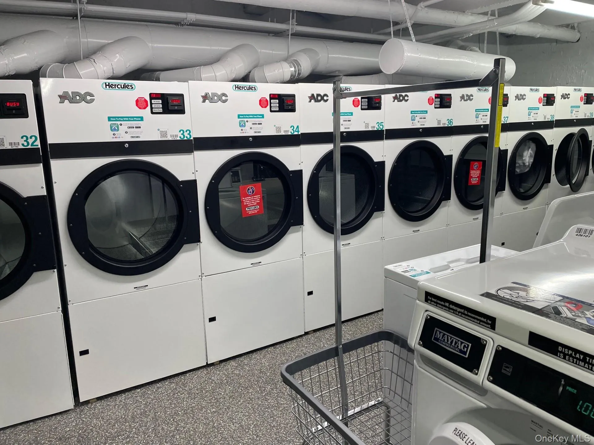 Shared laundry room featuring separate washer and dryer Shared laundry room featuring separate washer and dryer
