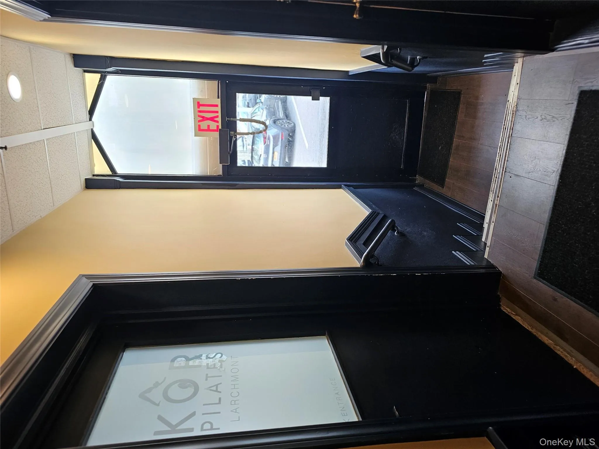 Doorway to outside featuring wood-type flooring and elevator Doorway to outside featuring wood-type flooring and elevator